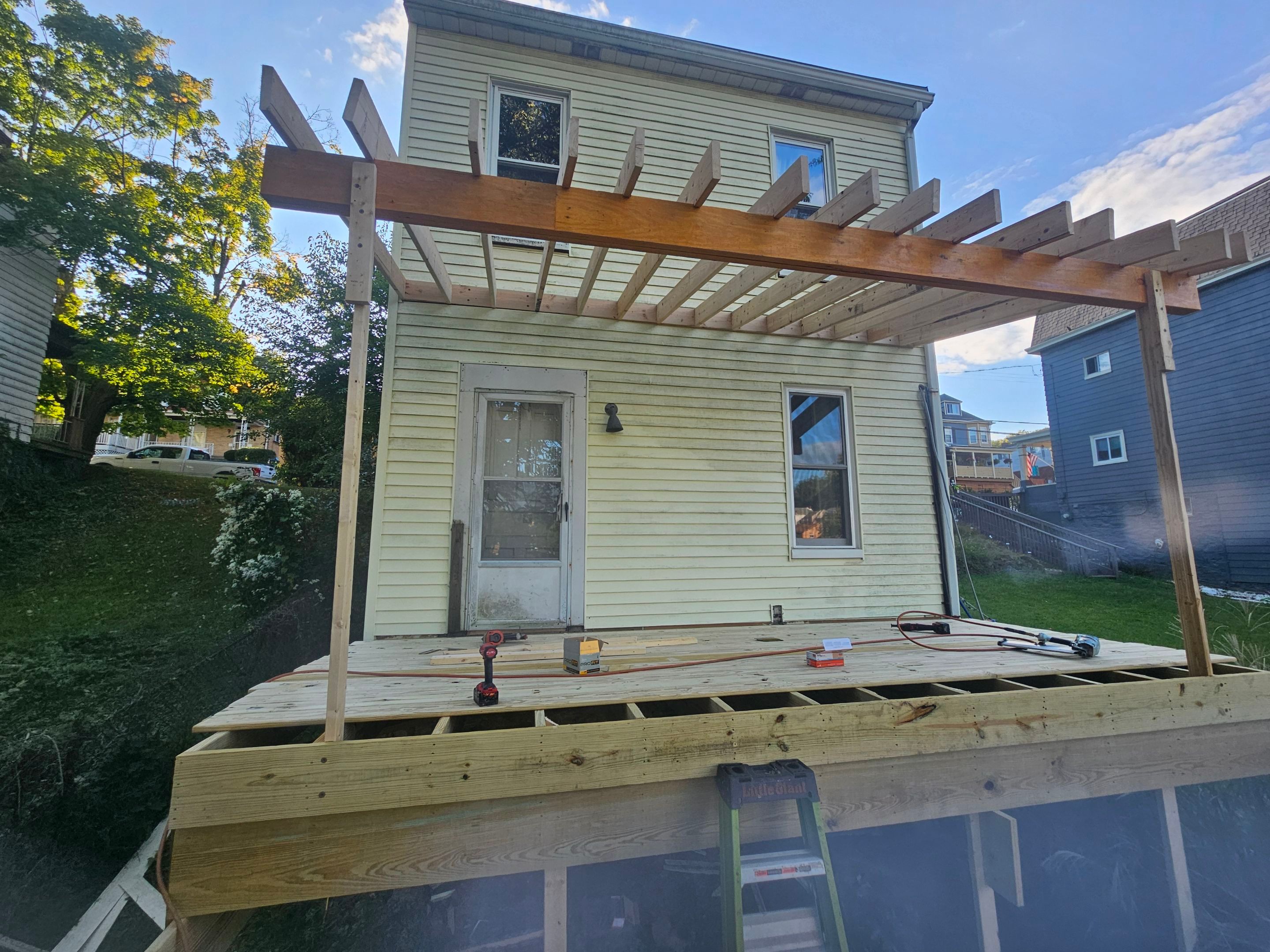 Deck and shed roof by Cousins Roofing Siding & Decks
