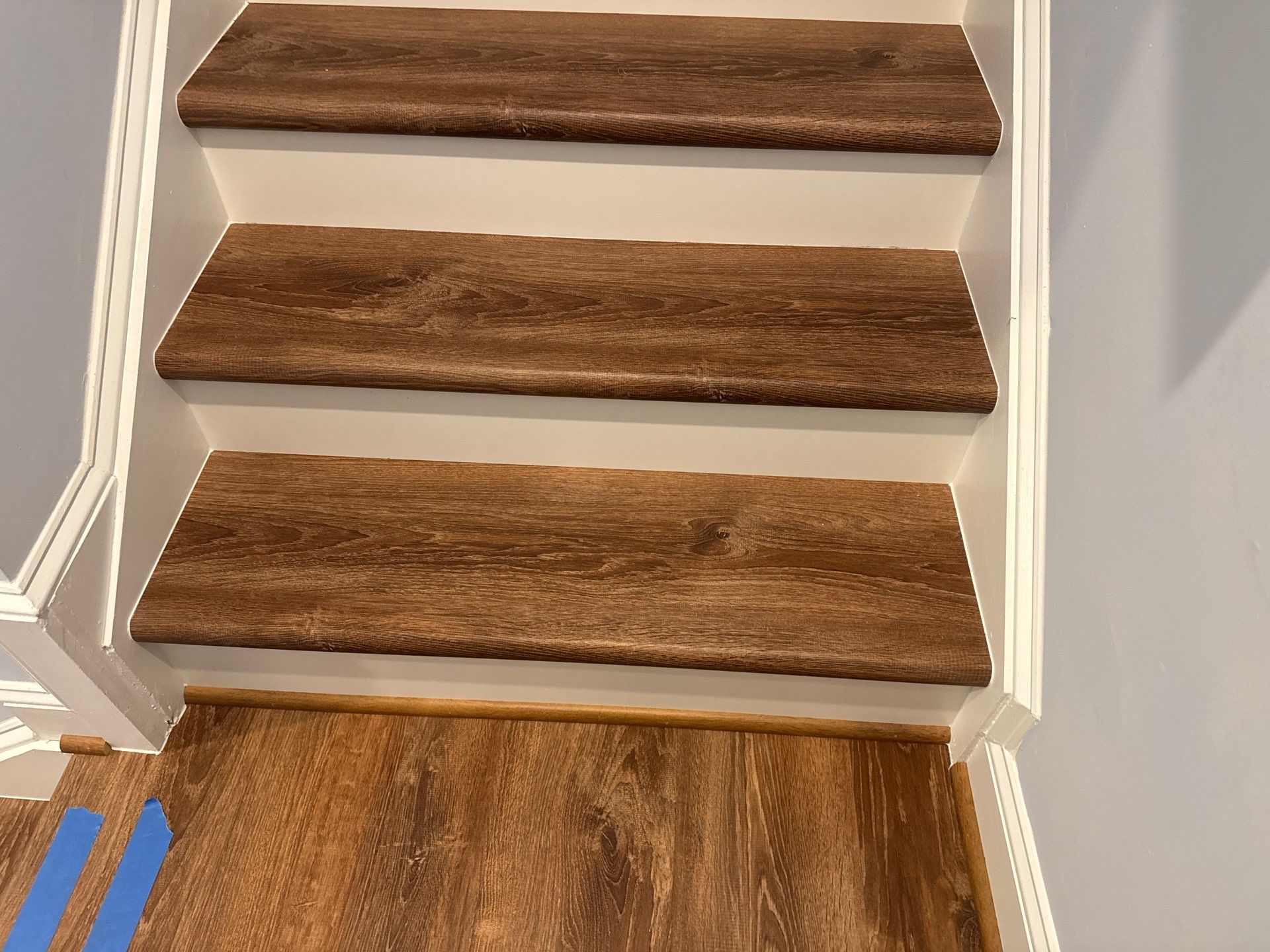 Stairway Installation using t vinyl stair tread and reversibleriser by La Bendicion Contruction Llc