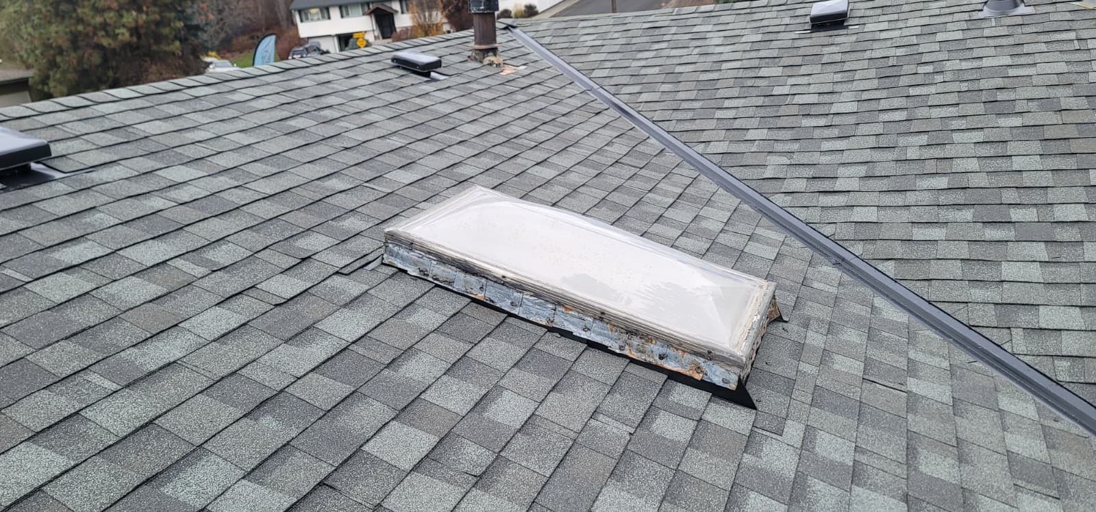 Residential Asphalt Shingle Roof Replacement and Skylight Installation in Spokane by Alpine Roofing