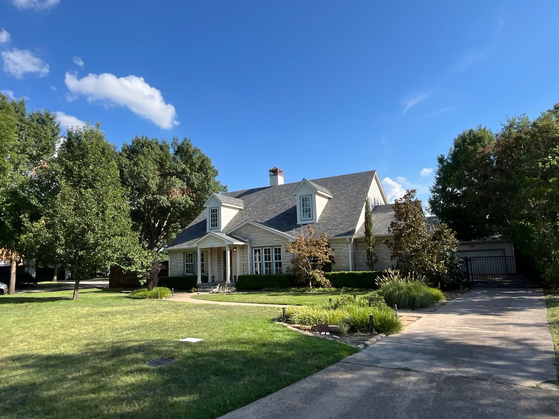 White brick with Malarkey Storm Grey by Tejas Roofworks + Restoration