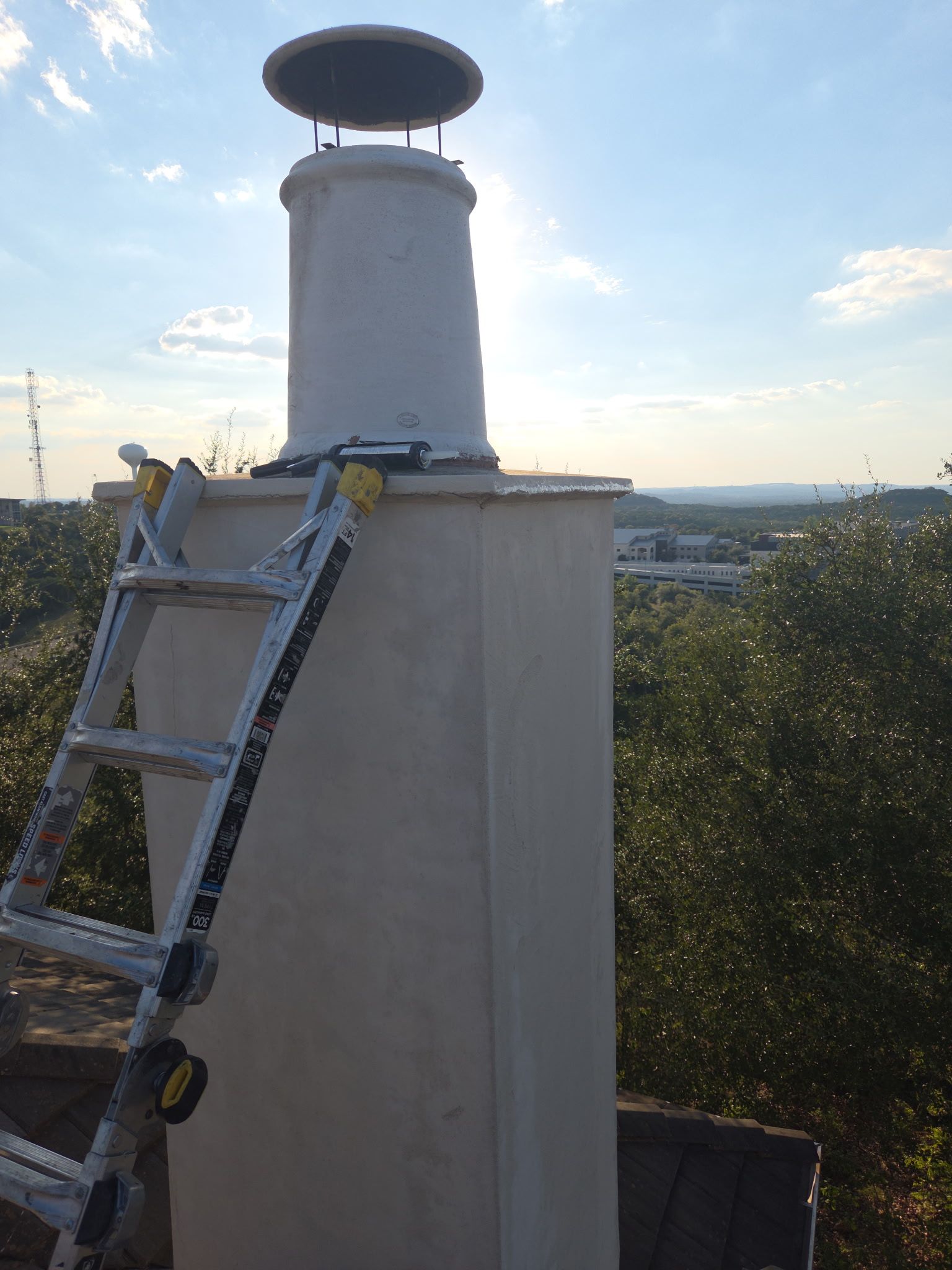 Tile roof and custom chimney cap by REPS Austin Area Roofer