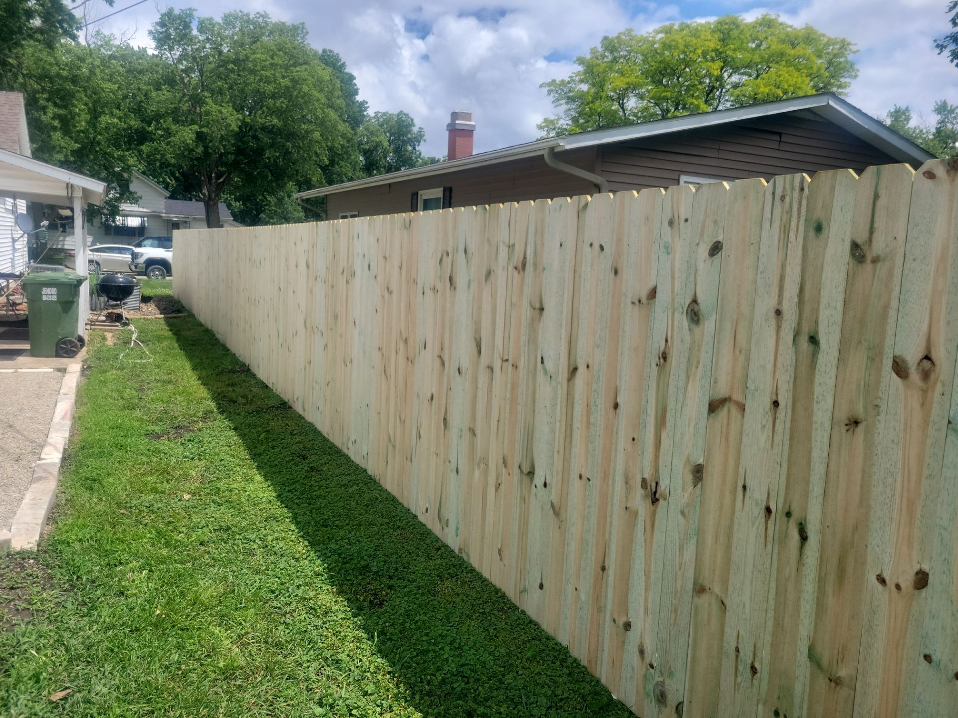 Pressure-Treated Wood Privacy Fence Installation in Charles City by Perfect Picket Fence and Stain