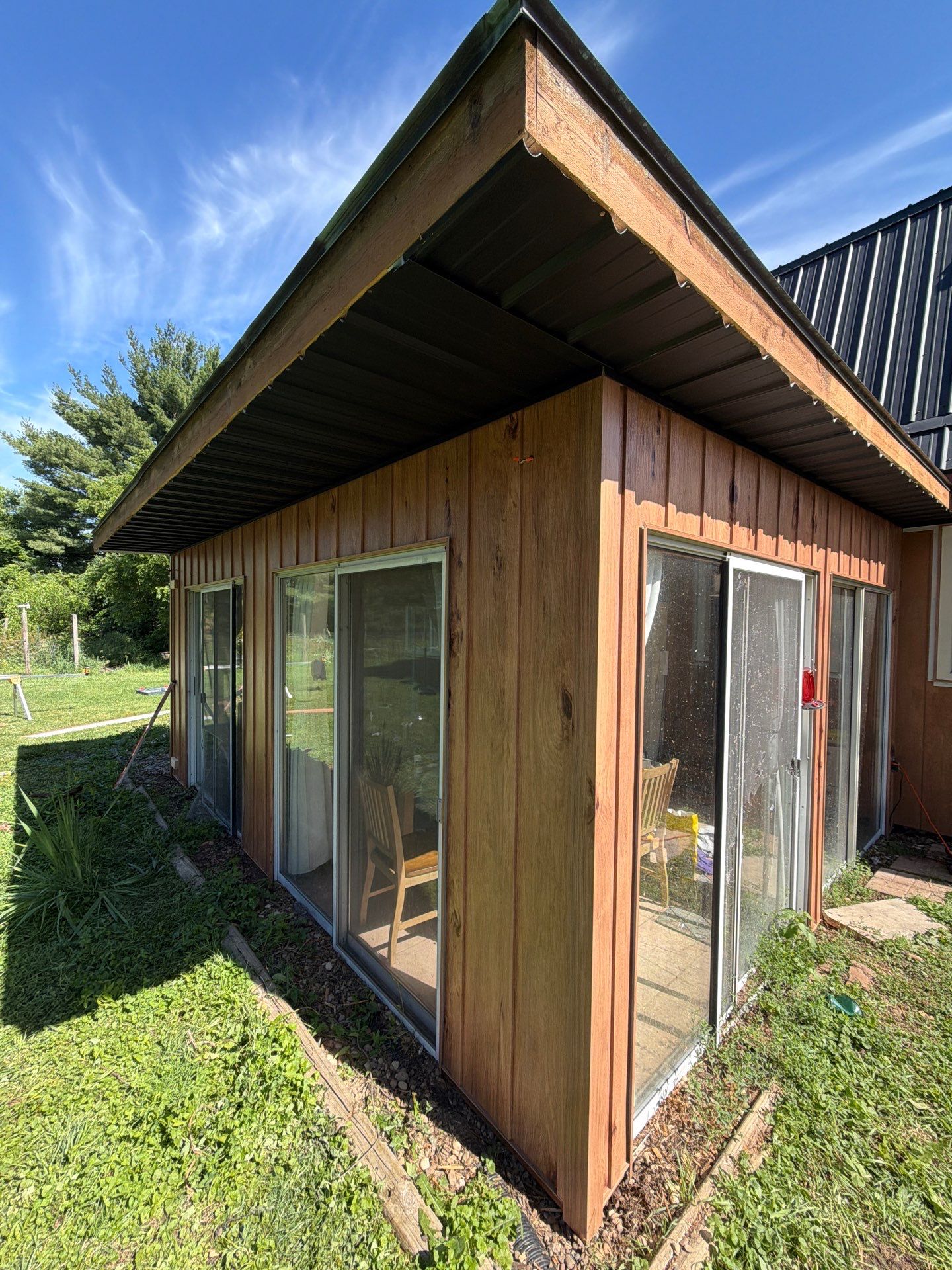 Complete Exterior Transformation with Textured Black Metal Roofing and Hickory Board-and-Batten Siding in Hebron by BZ Exteriors