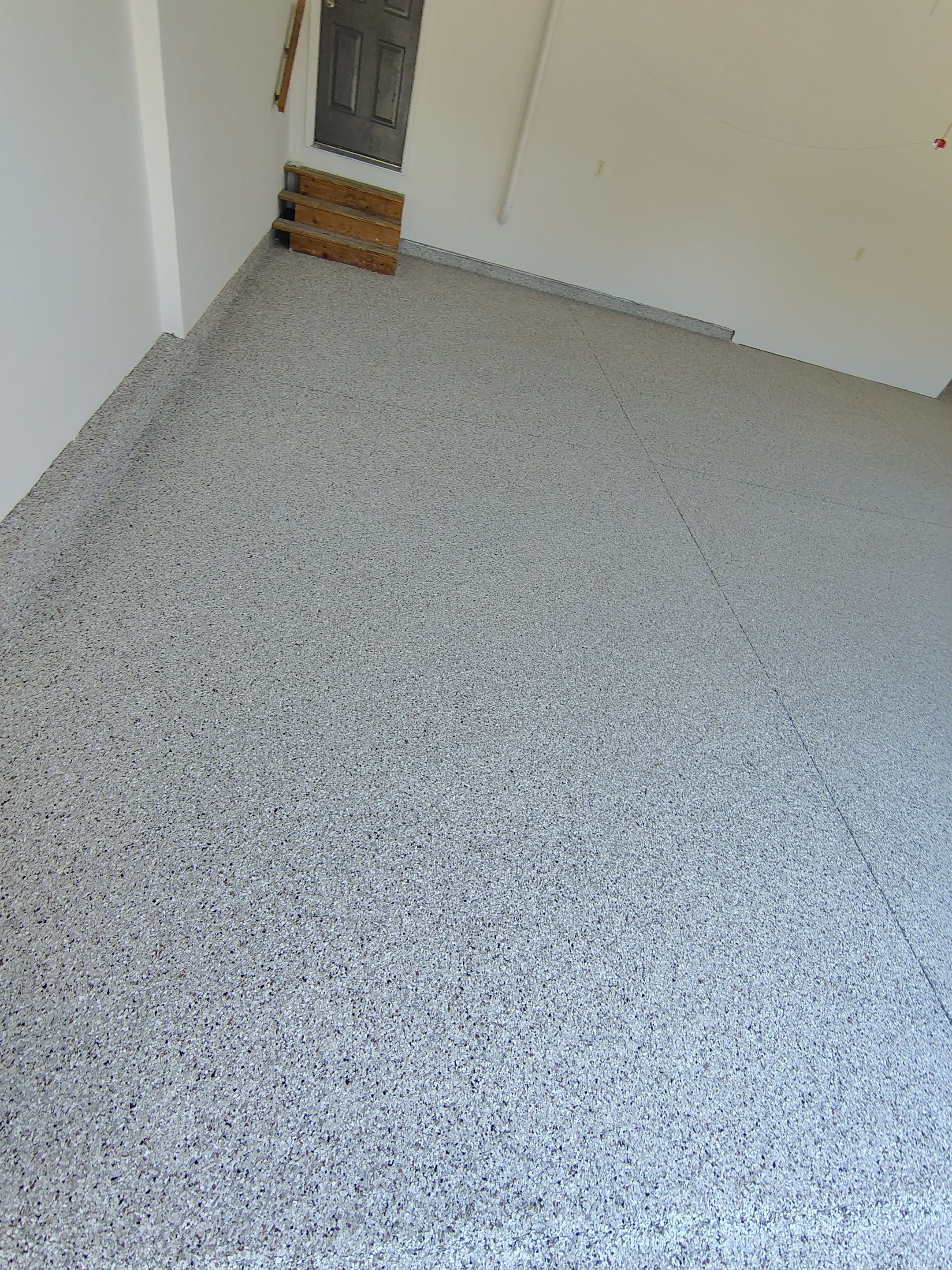 Custom Grey Speckled Epoxy Floor Coating for Sioux Falls Garage by Select Painting, Coatings & Garage Cabinets
