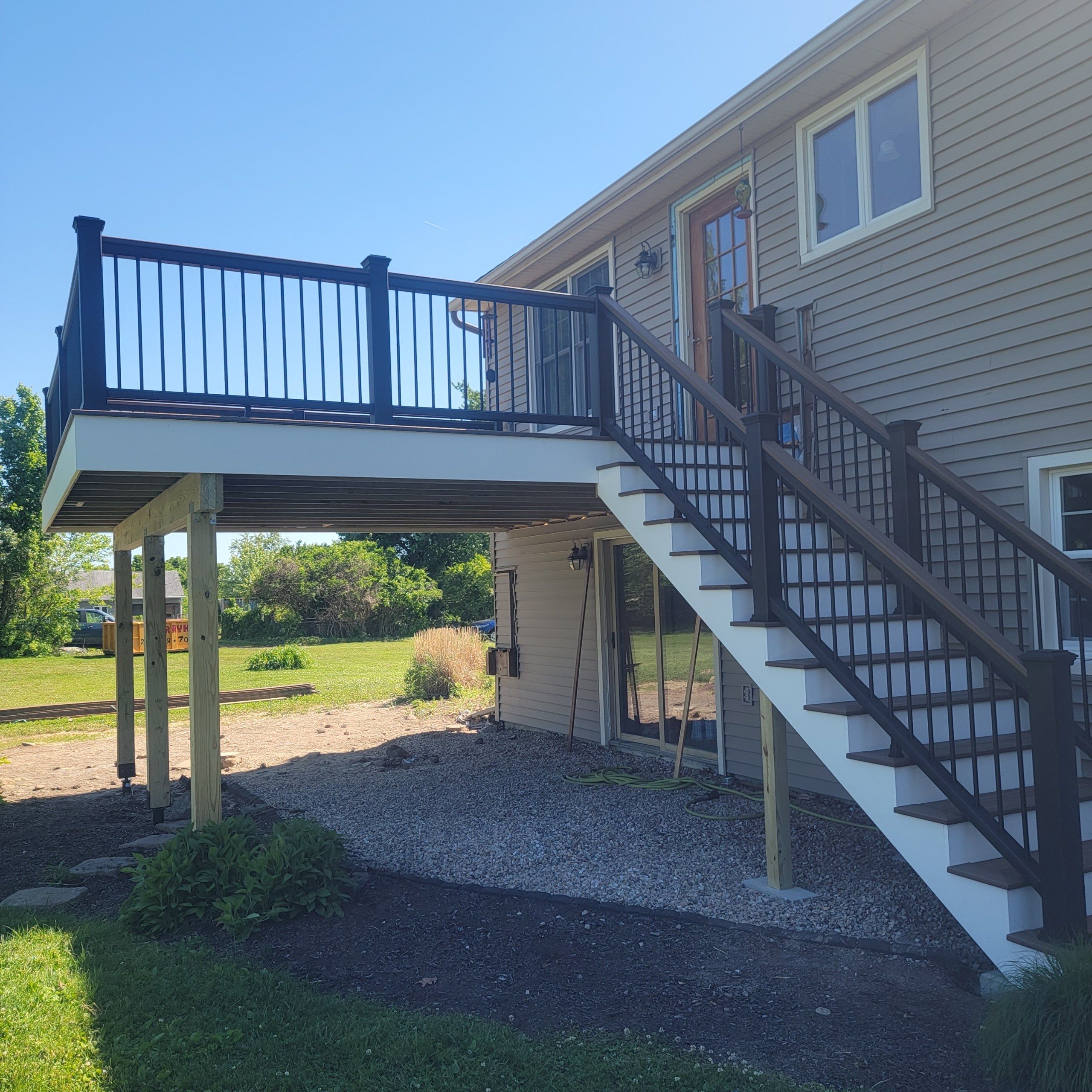 Deck Replacement using Trex Tropical Havana Gold and matching transcend cocktail railing.  by DiGiorgi Roofing and Siding Inc