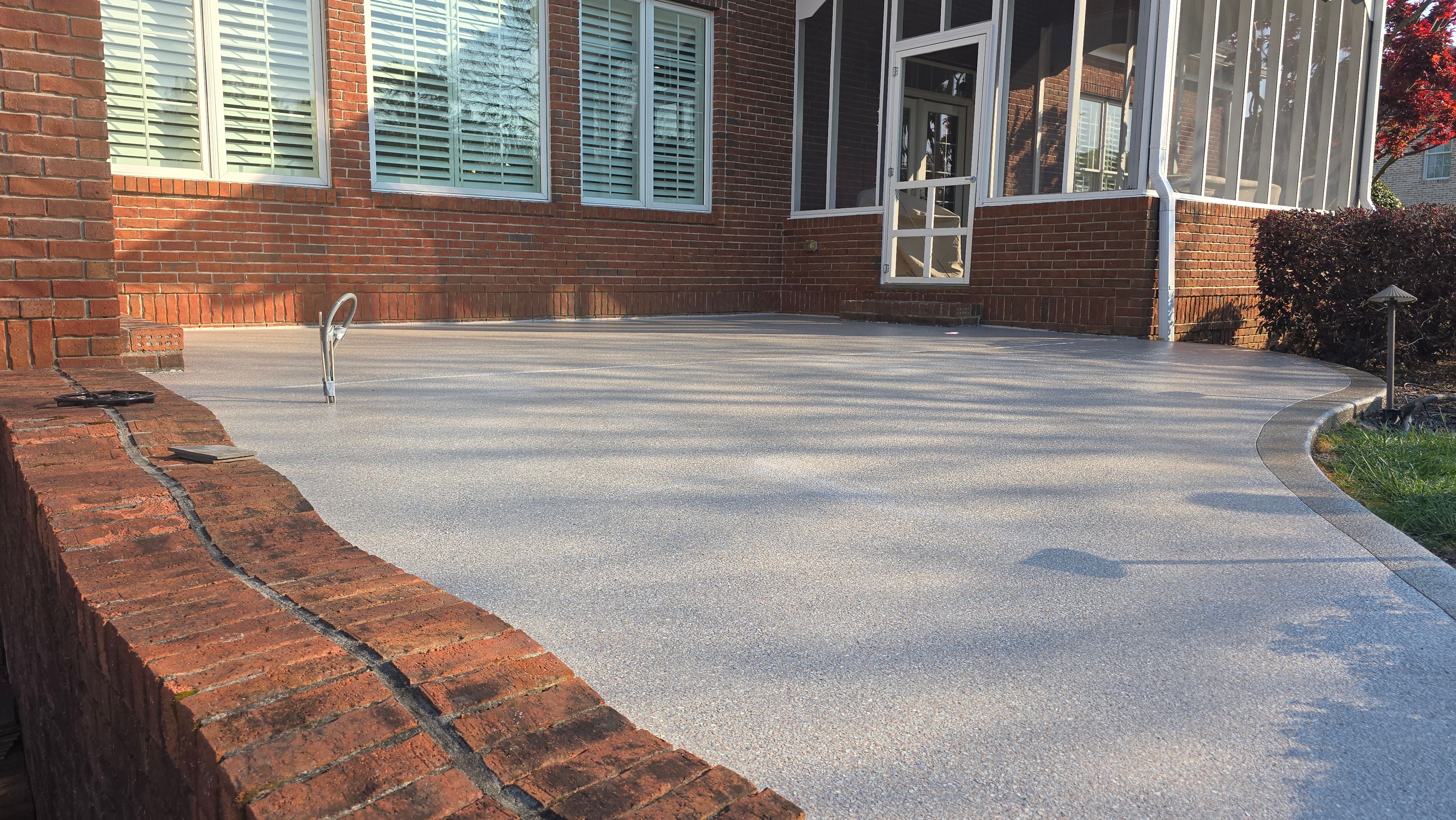 Patio in Pumice with Obsidian Border  by Elite Floor Solutions