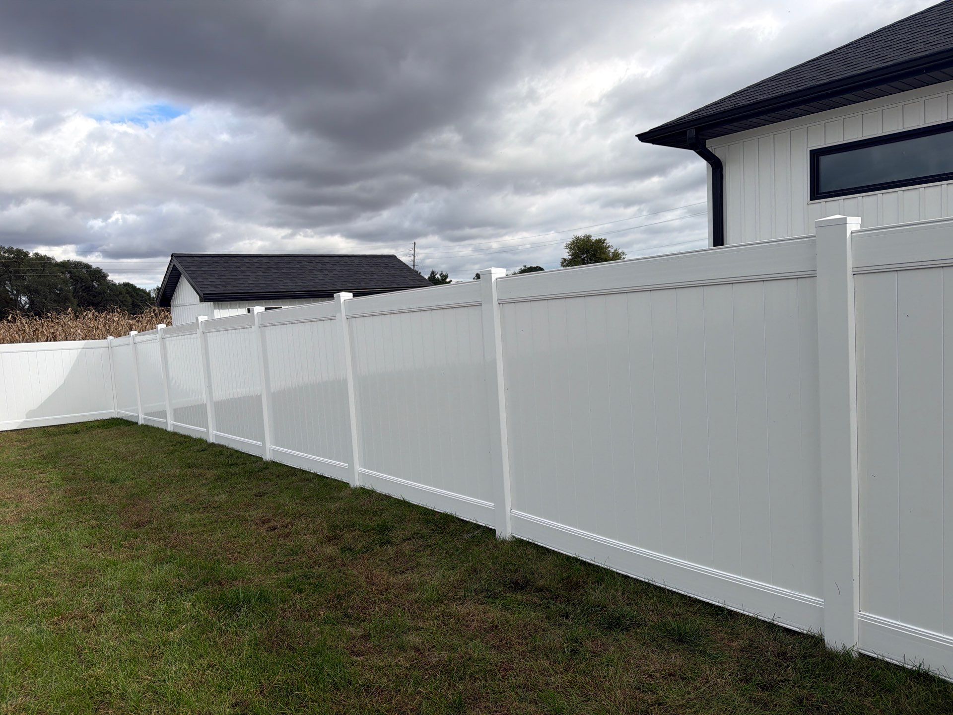 Residential White Vinyl Privacy Fence Installation in Janesville by Perfect Picket Fence and Stain
