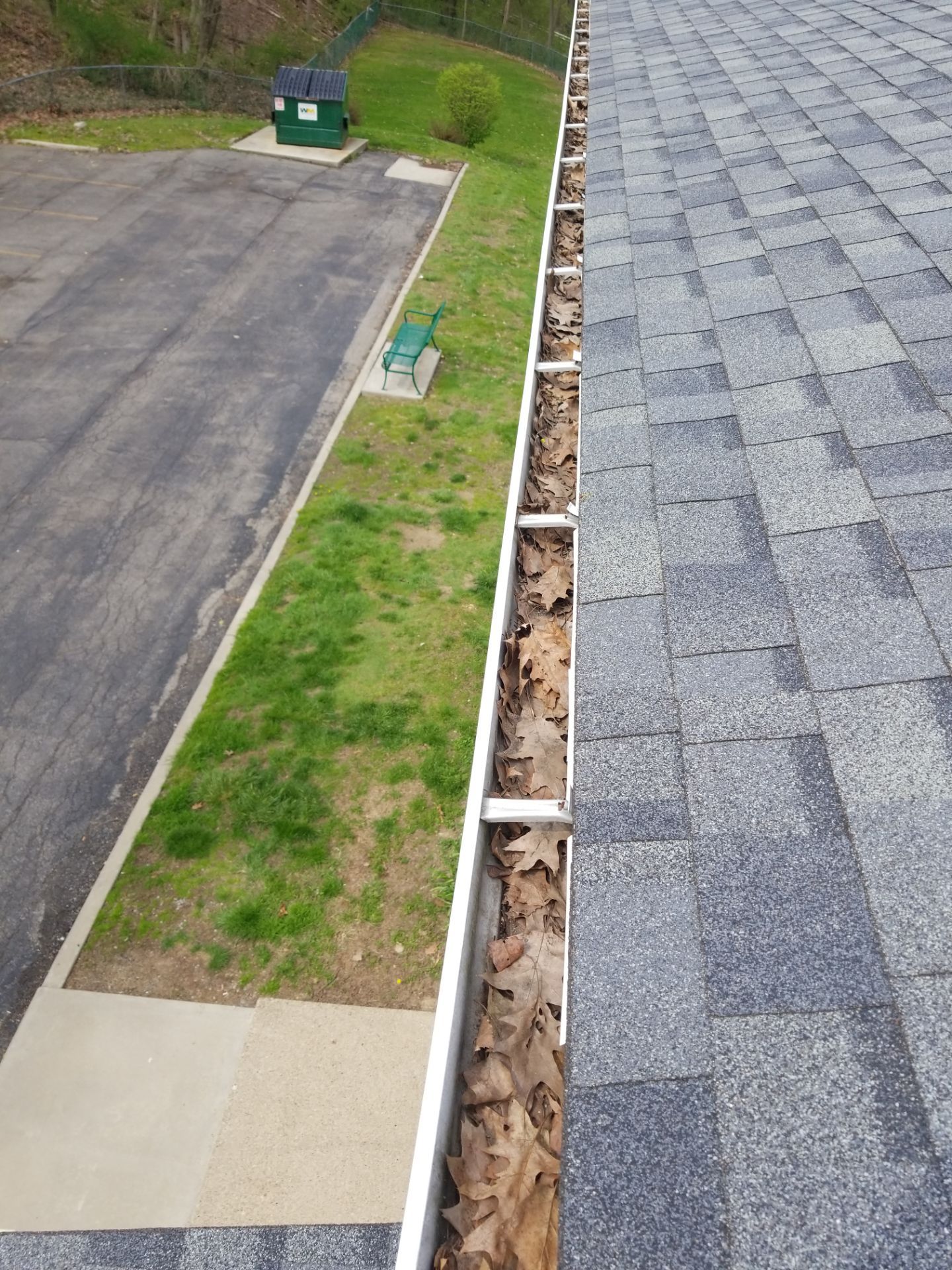 Commercial gutter cleaning Erie, PA before photo with filled gutters
