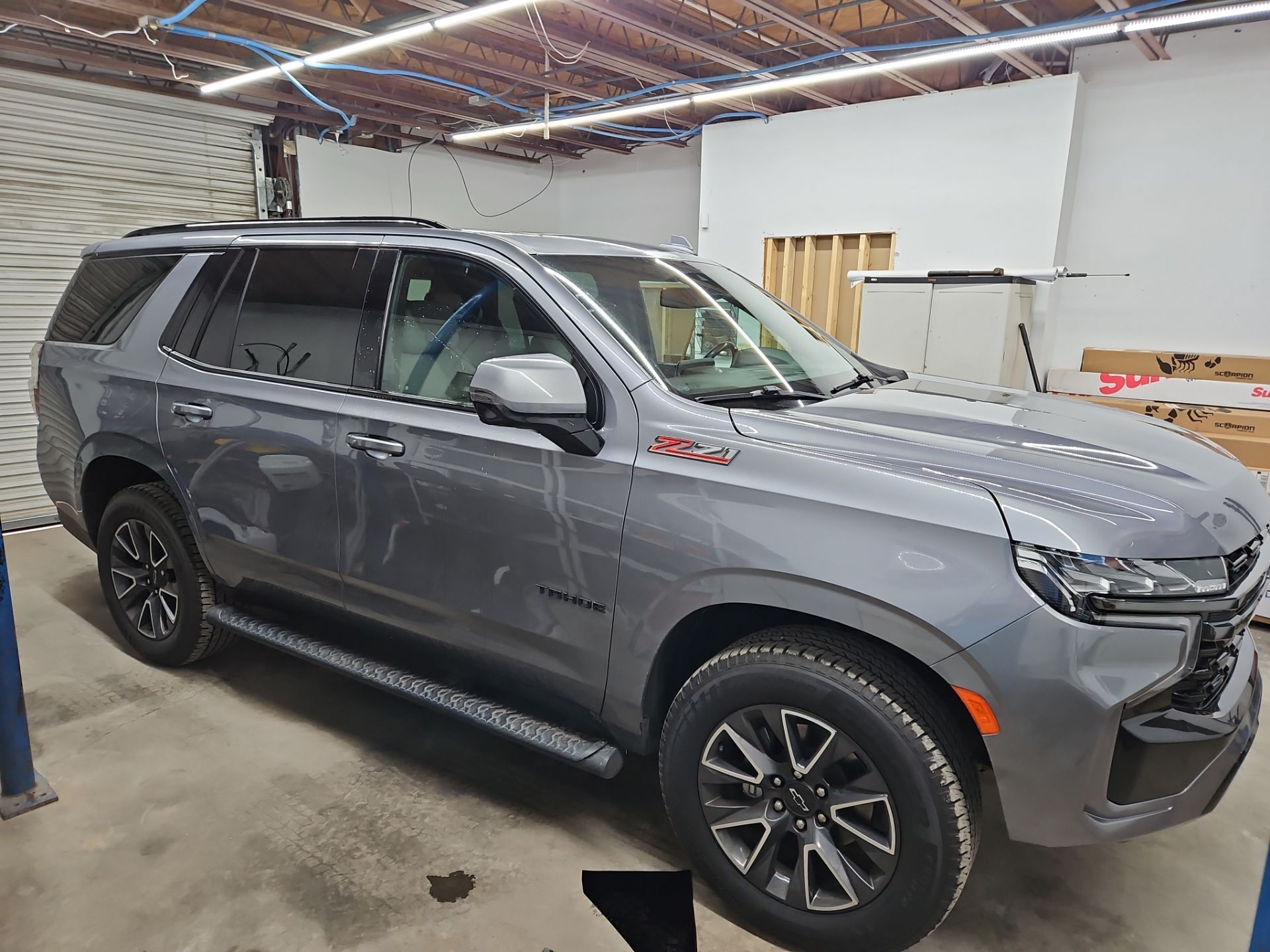 the service being done is window tinting on a gray suv the company is applying a film to the windows to reduce glare and heat inside the vehicle the tinting enhances privacy and improves the overall look of the car it appears to be a new model with a clean finish being prepared for a professional installation