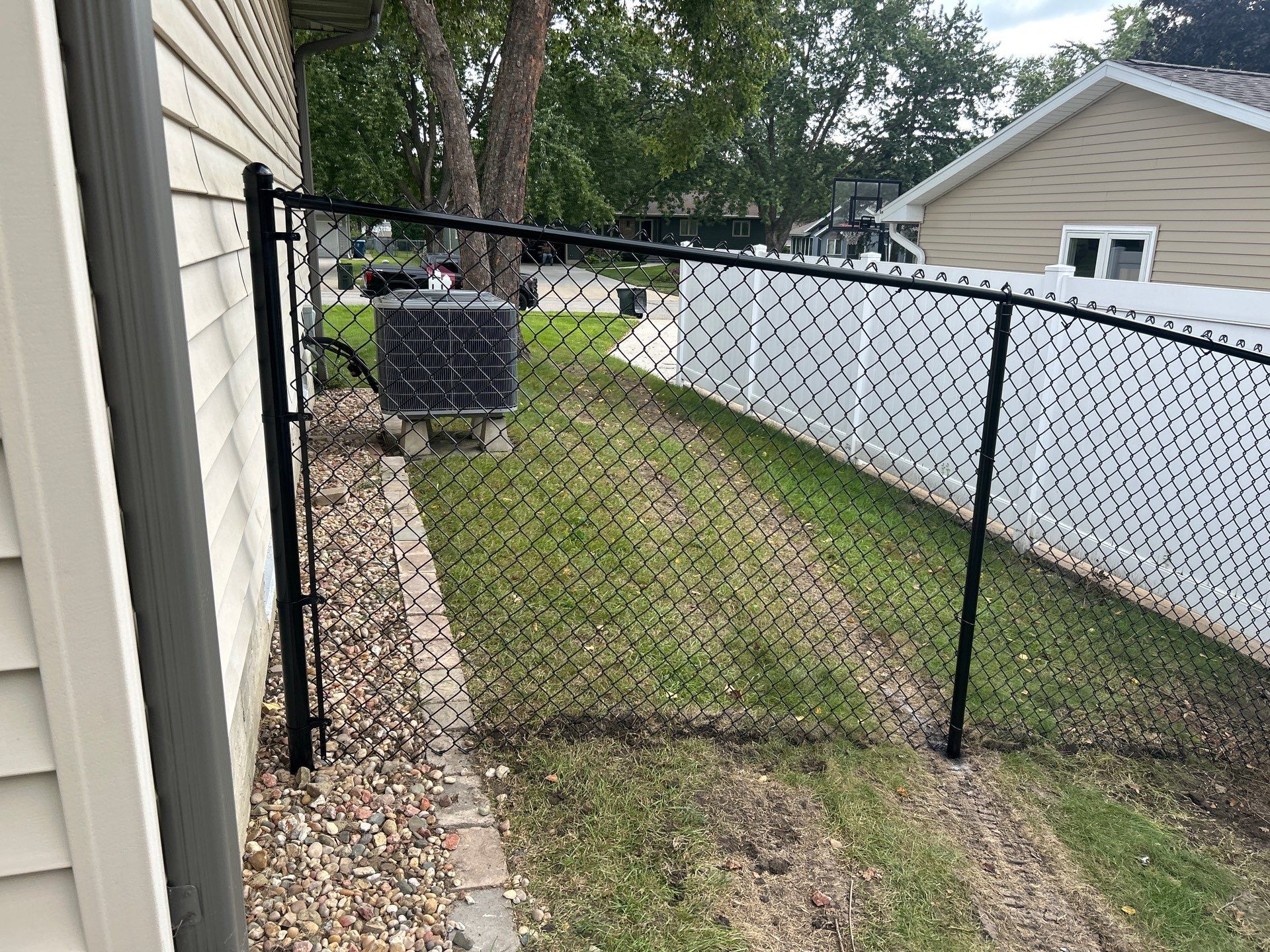 Black Vinyl Coated Chain Link Fence Installation in Waterloo by Perfect Picket Fence and Stain