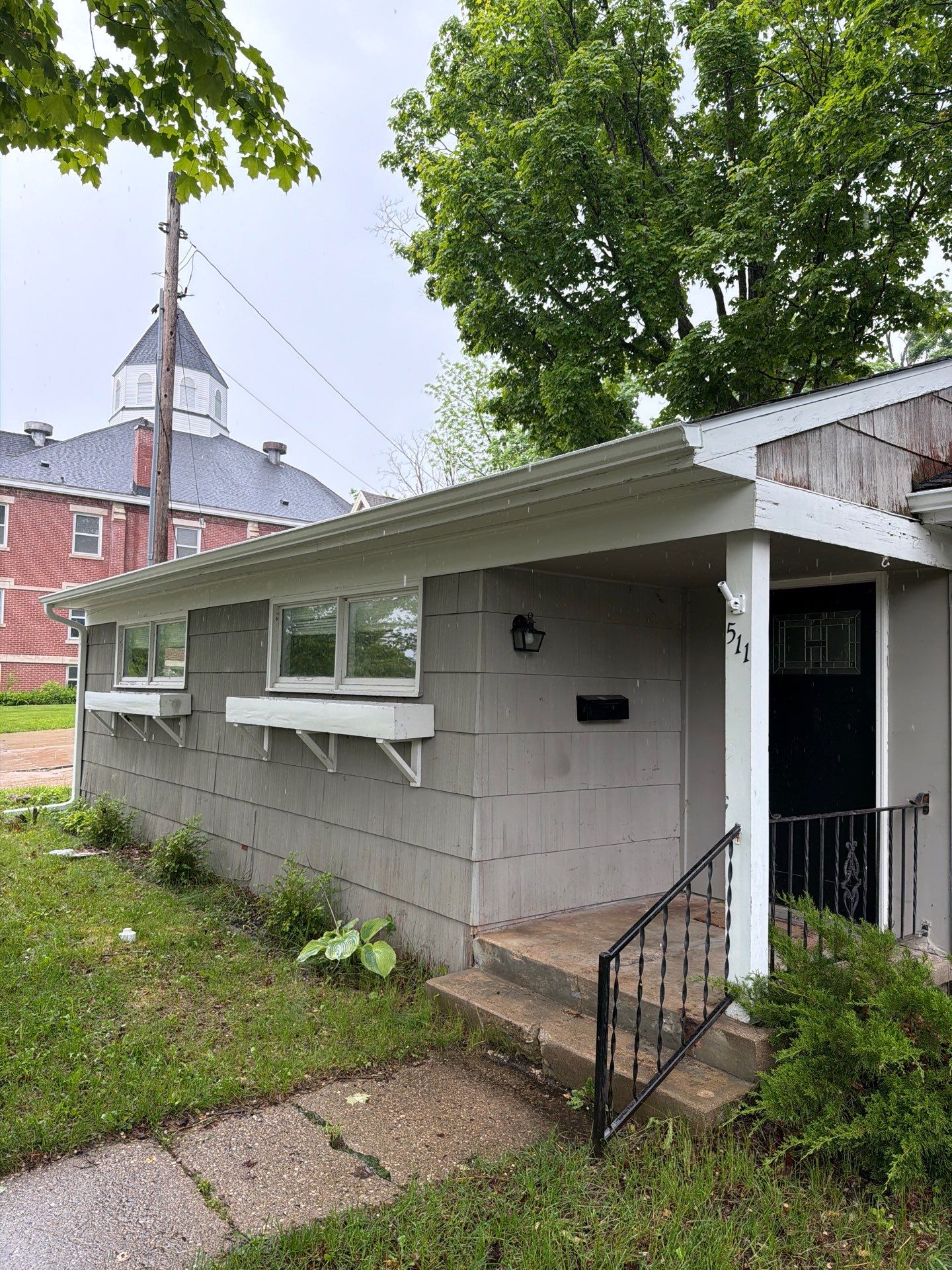 White Gutter and Downspout System Installation in Petoskey by Rainbow Seamless Systems