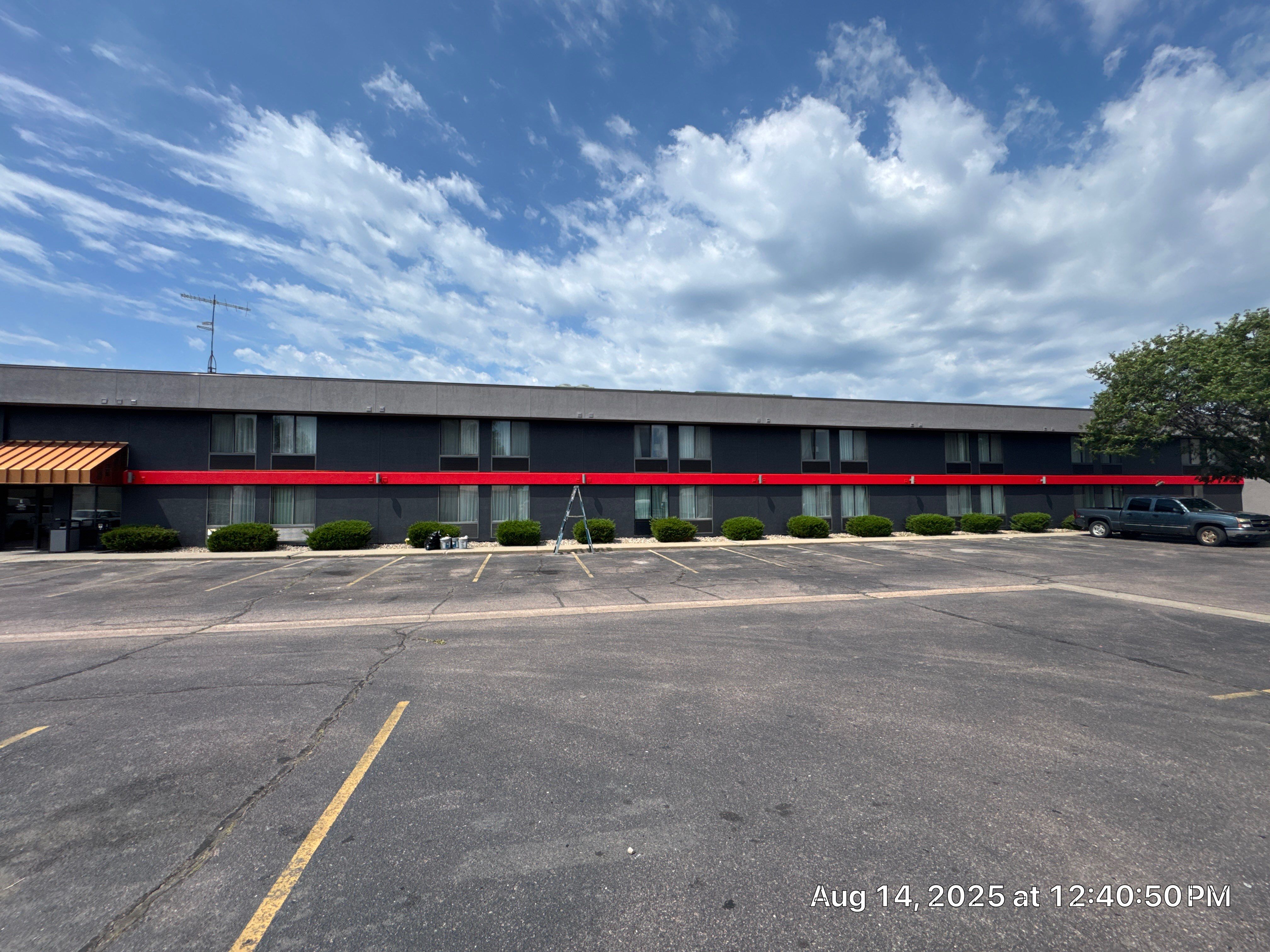 Commercial Exterior Painting with Stucco and Bold Red Accent Trim by Select Painting, Coatings & Garage Cabinets