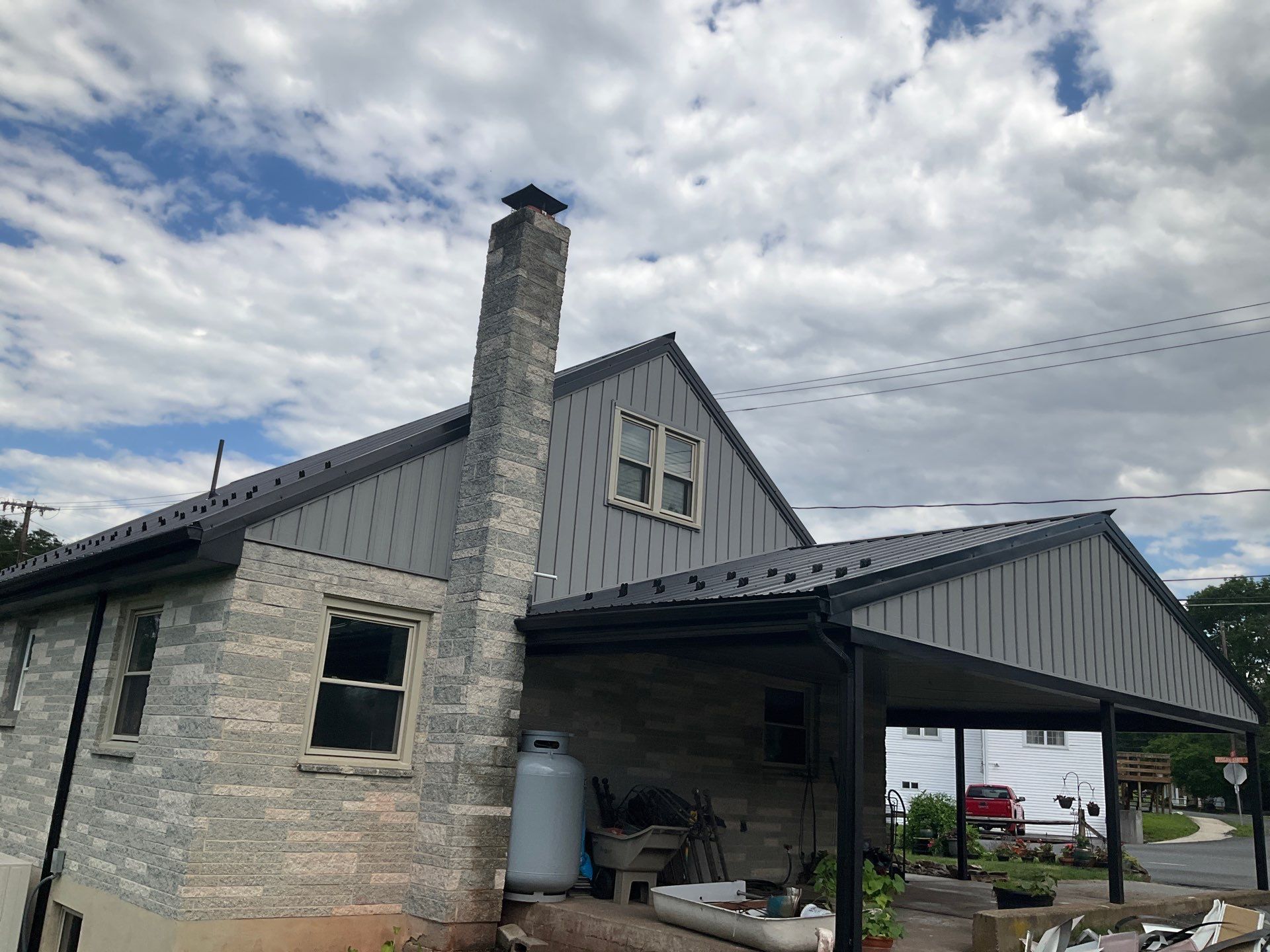 Metal Roofing, Board & Batten Siding, and Entry Door Transformation by Esh Builders