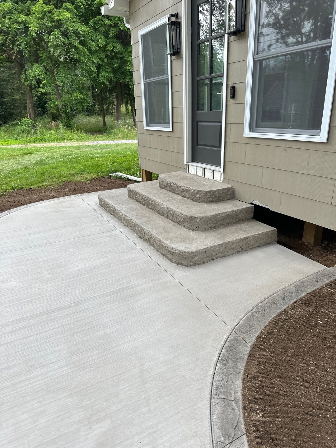 Broom finished concrete patio and sidewalk  by NG Masonry & Construction LLC