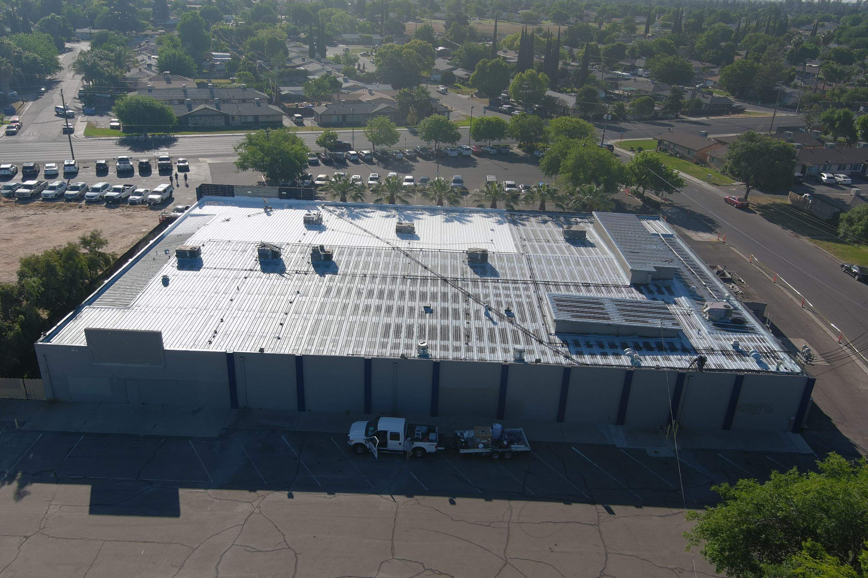 Metal roof restoration on commercial roof using Conklin Benchmark/ PUMA XL acrylic coatings over metal and foam by Straight Edge Roofing Inc