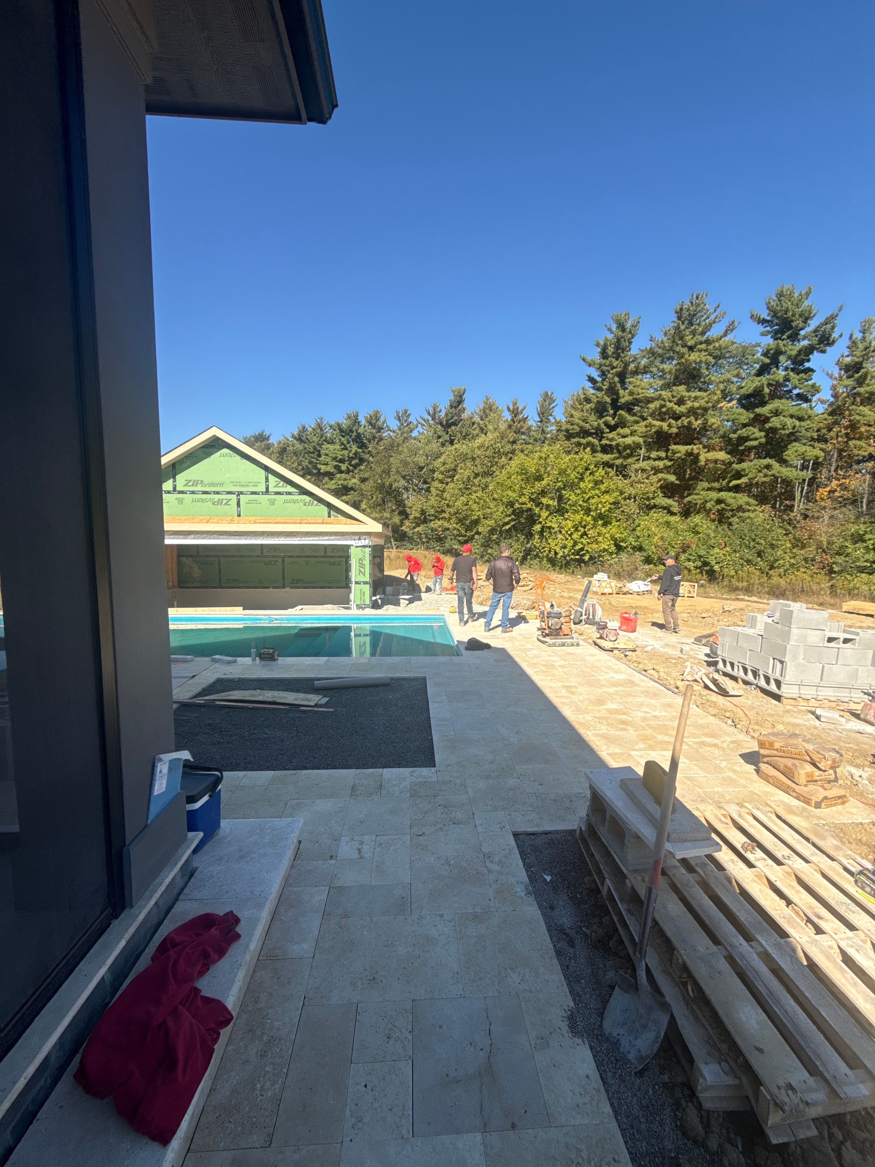 Custom Travertine Pool Deck with Artificial Turf Insets in Delaware by Southwest Greens Midwest