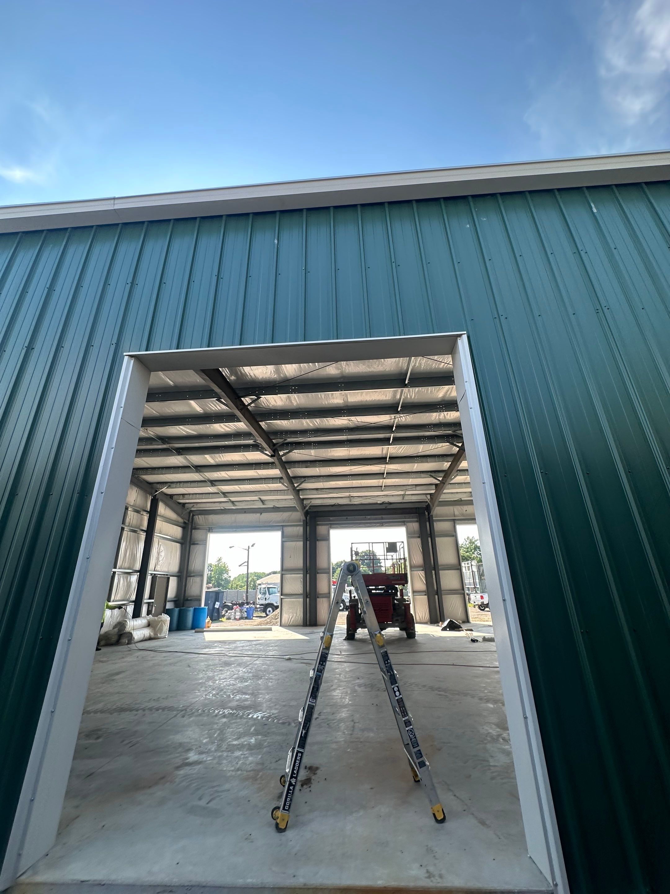 Dark Green Metal Siding by Reimagine Roofing