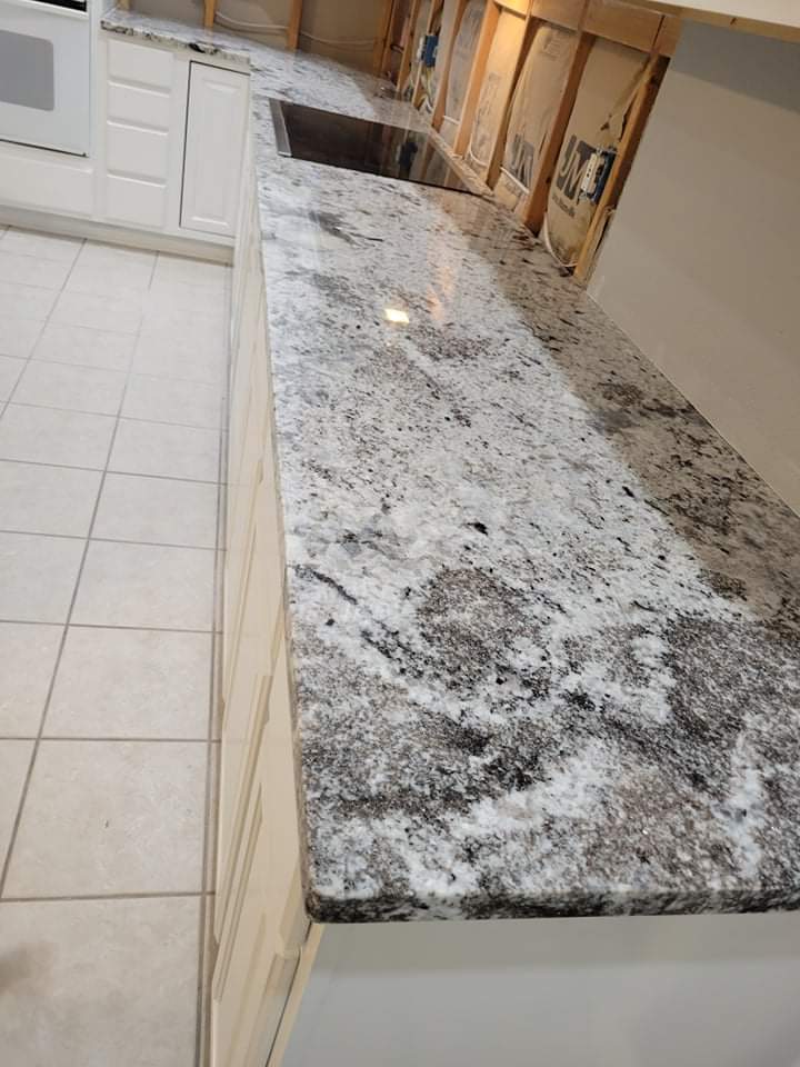 Kitchen countertops using White Normandy Granite by Mena stone surfaces