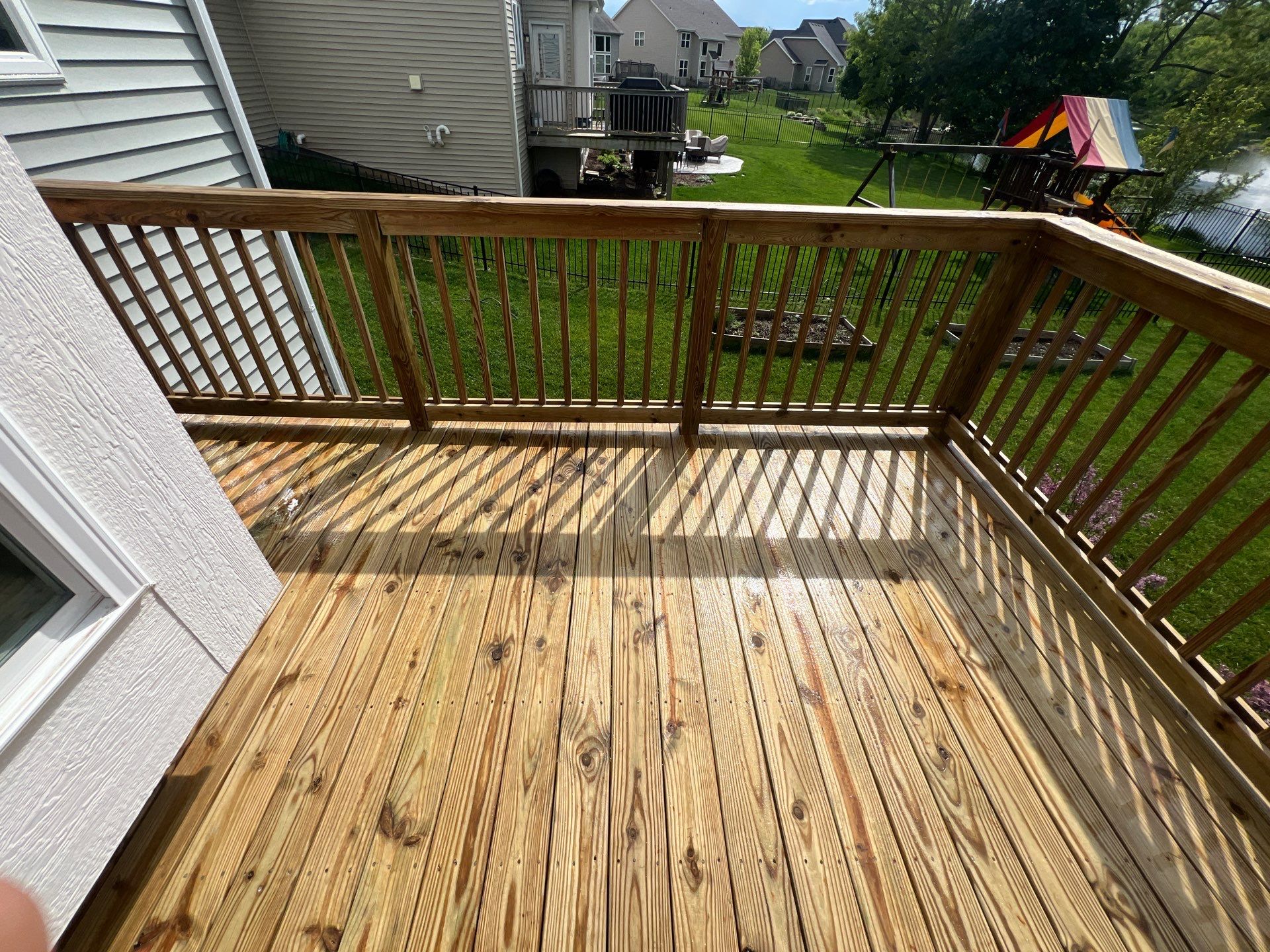 wood deck cleaning and staining by Northern Power Washing LLC.