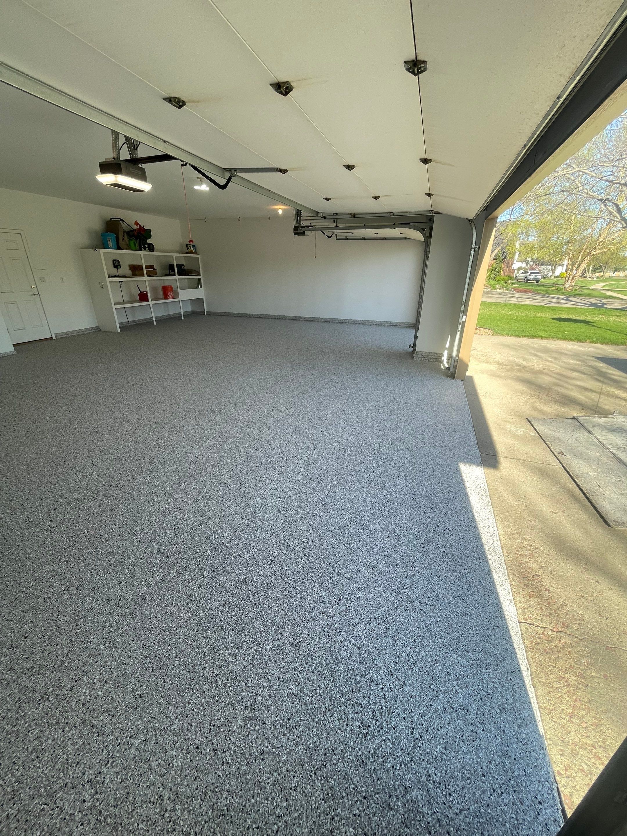 Yankton Garage Floor Restoration with Gray Speckled Epoxy Coating by Select Painting, Coatings & Garage Cabinets