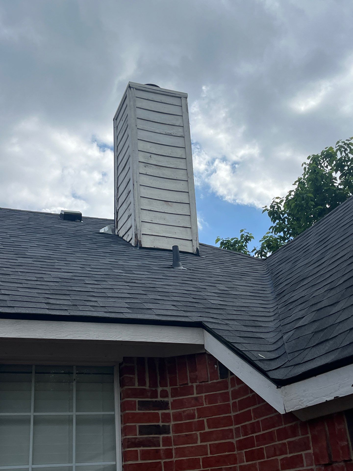 Red brick with Malarkey Midnight Black  by Tejas Roofworks + Restoration