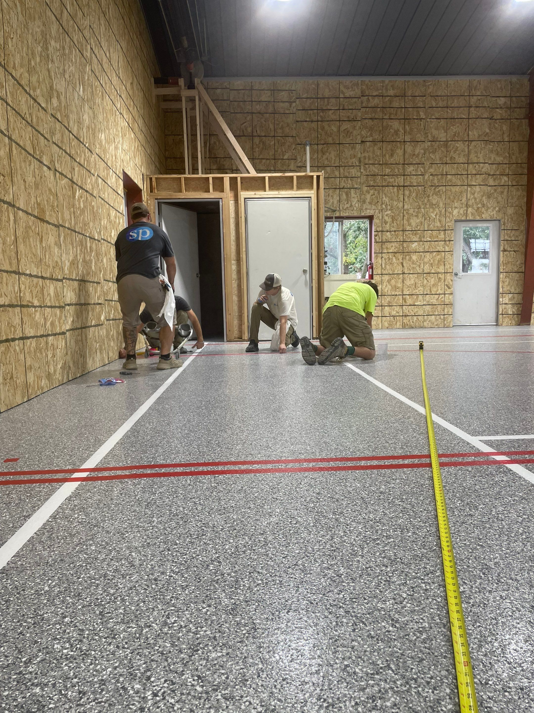 Custom Polyurea Shop Floor with Basketball Court Lines in Rock Valley by Select Painting, Coatings & Garage Cabinets