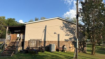 Vinyl Siding and Custom Deck Installation for Lyles Residential Property