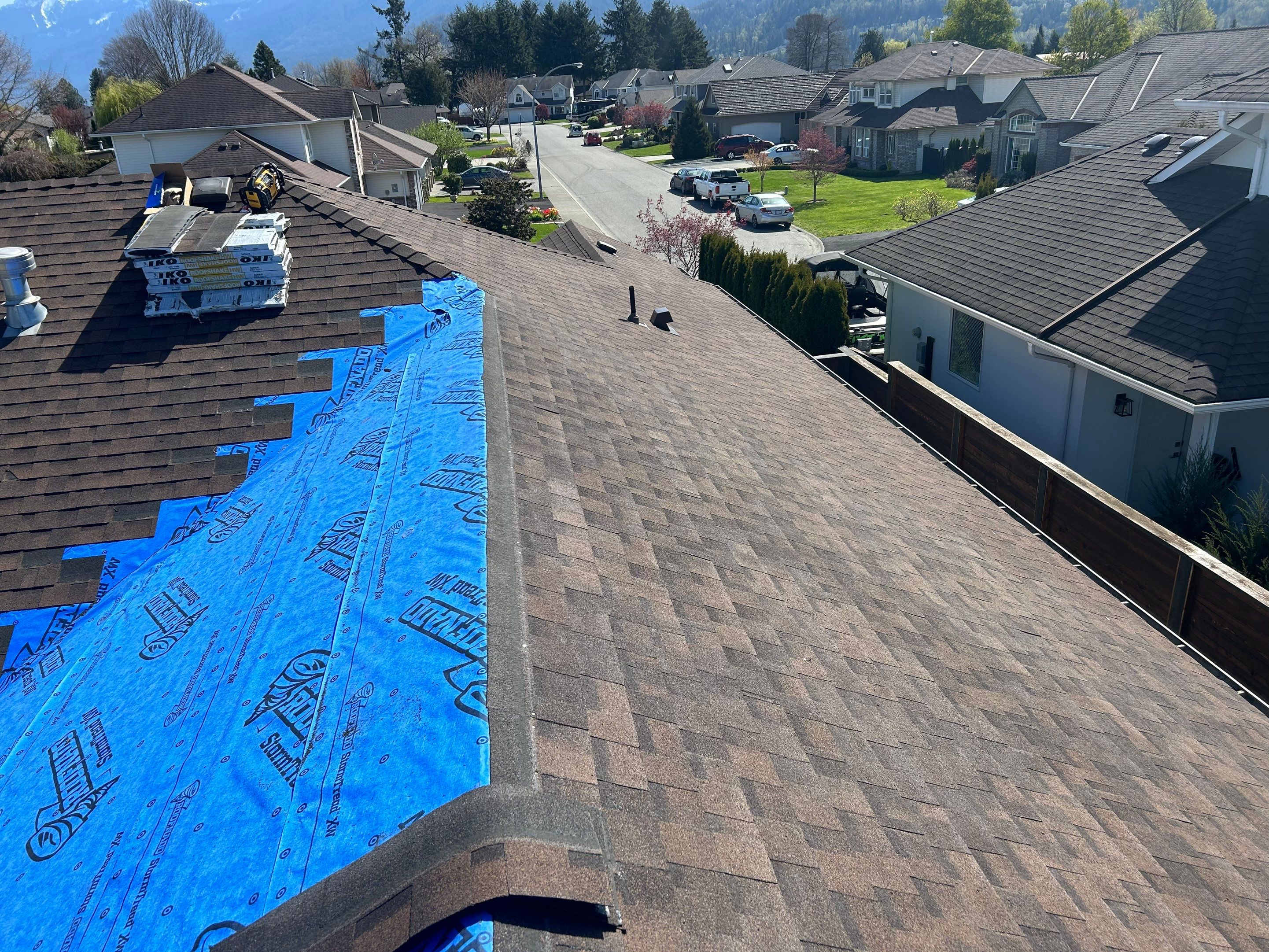 Residential patio roof extension with IKO Dual Brown shingles by Top Notch Roofing Inc