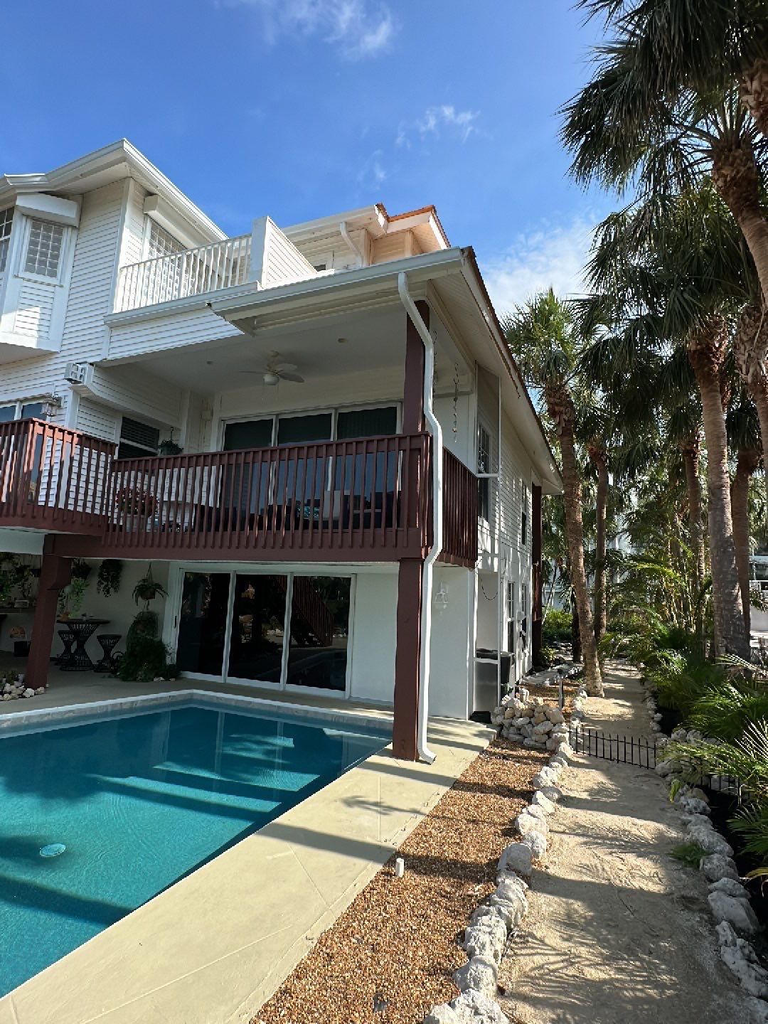 White K-Style Gutters Installed with White Downspouts in Sanibel FL by Gutter Professors