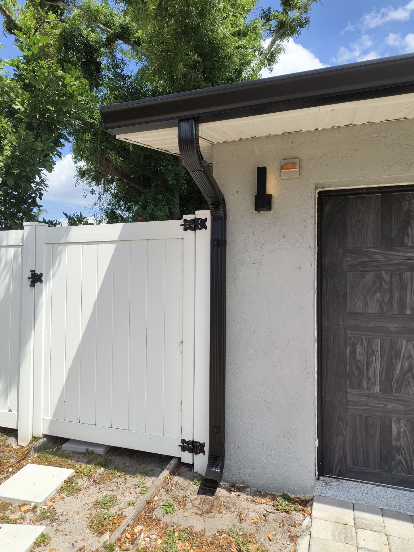 Black Seamless Gutters using 7 inch seamless gutters & New White Soffit in Sarasota FL by Gutter Professors