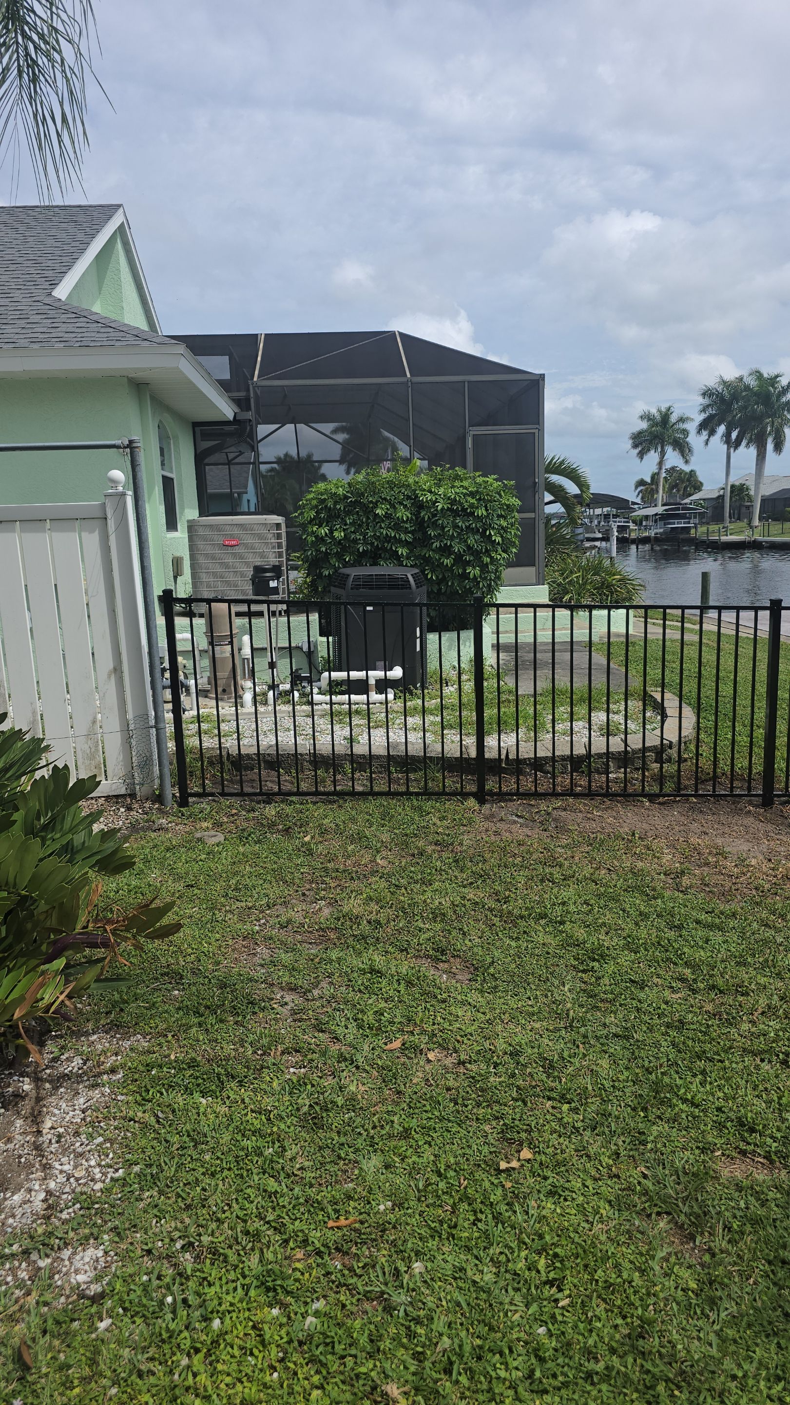 Black Aluminum Picket Fence Installation for Port Charlotte Canal Home by True Fence LLC