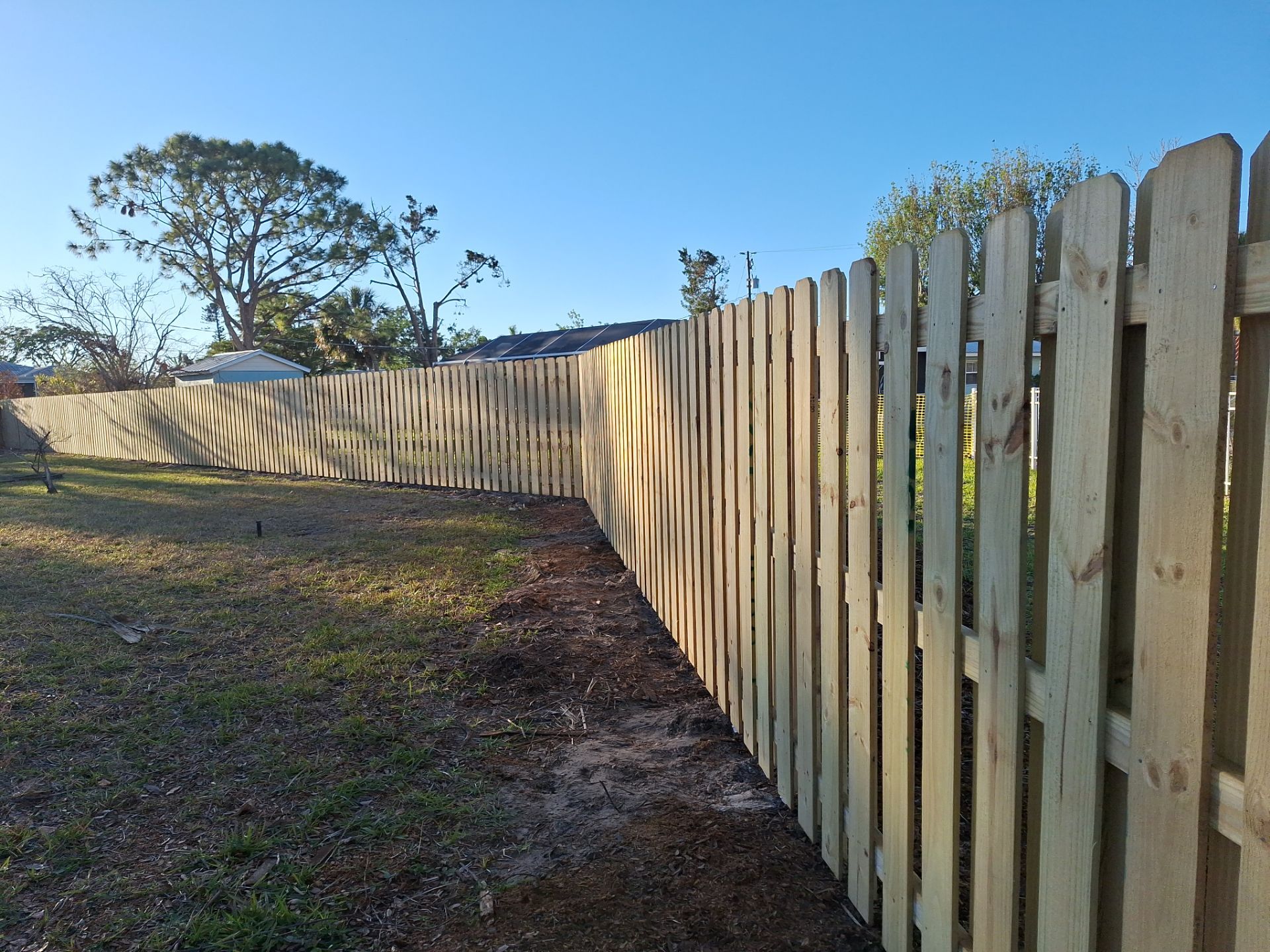 Wood Fence Installation using 6ft Pressure-Treated Wood Board-On-Board Privacy Fence with a 4Ft 3 Rail White Aluminum Fence by Asap fence and gates, LLC
