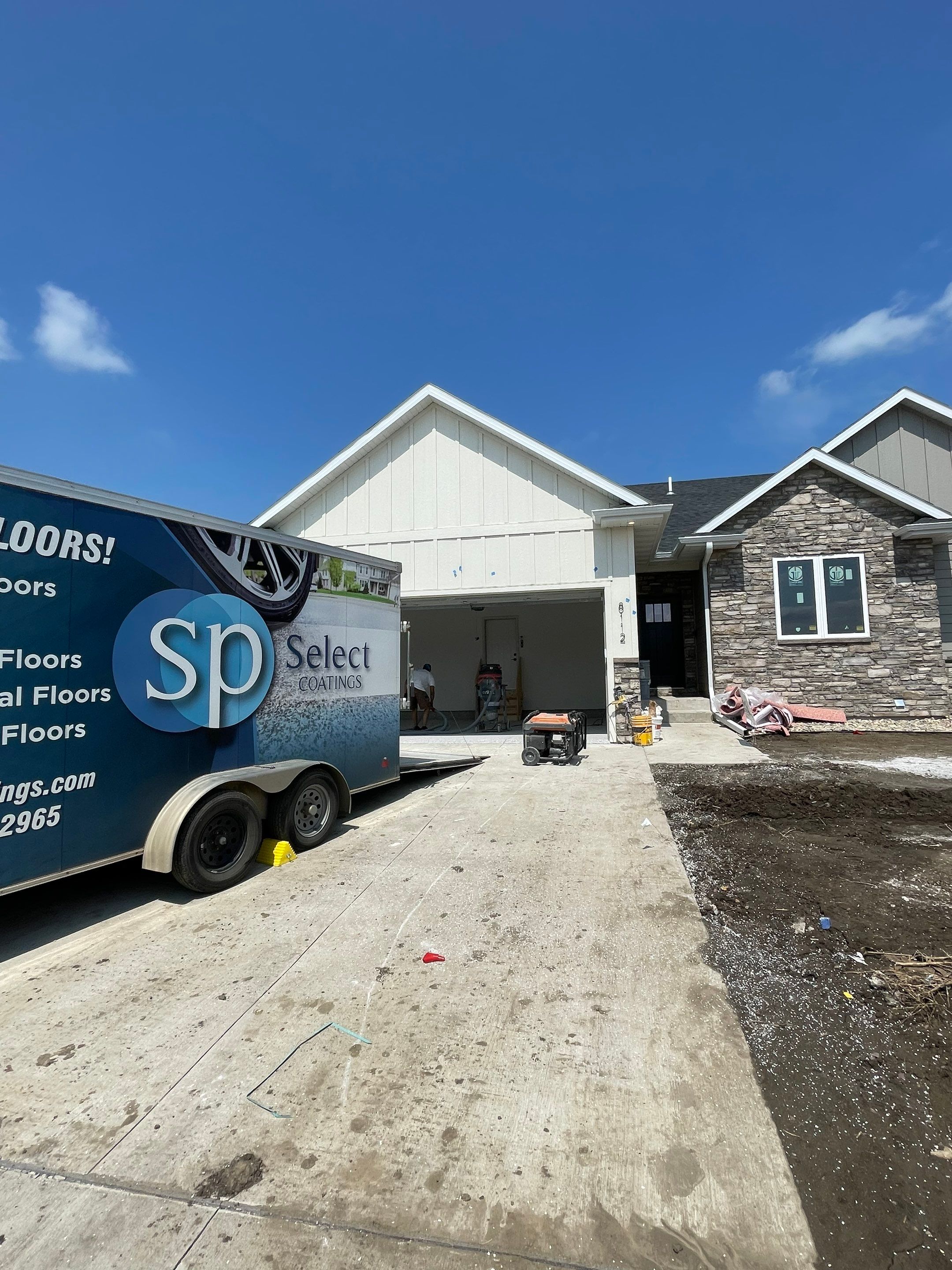 Grey Speckled Garage Floor Coating in Sioux Falls by Select Painting, Coatings & Garage Cabinets