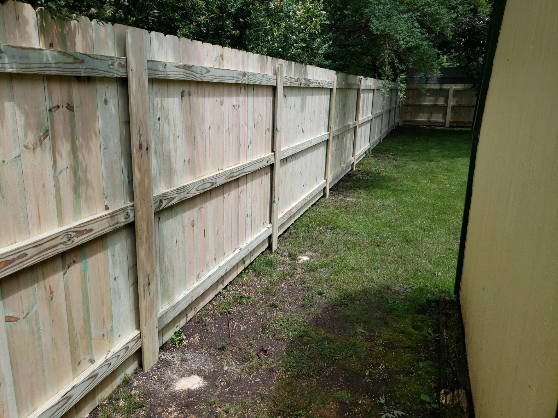 Custom Wood Privacy Fence Installation for Charles City Backyard by Perfect Picket Fence and Stain