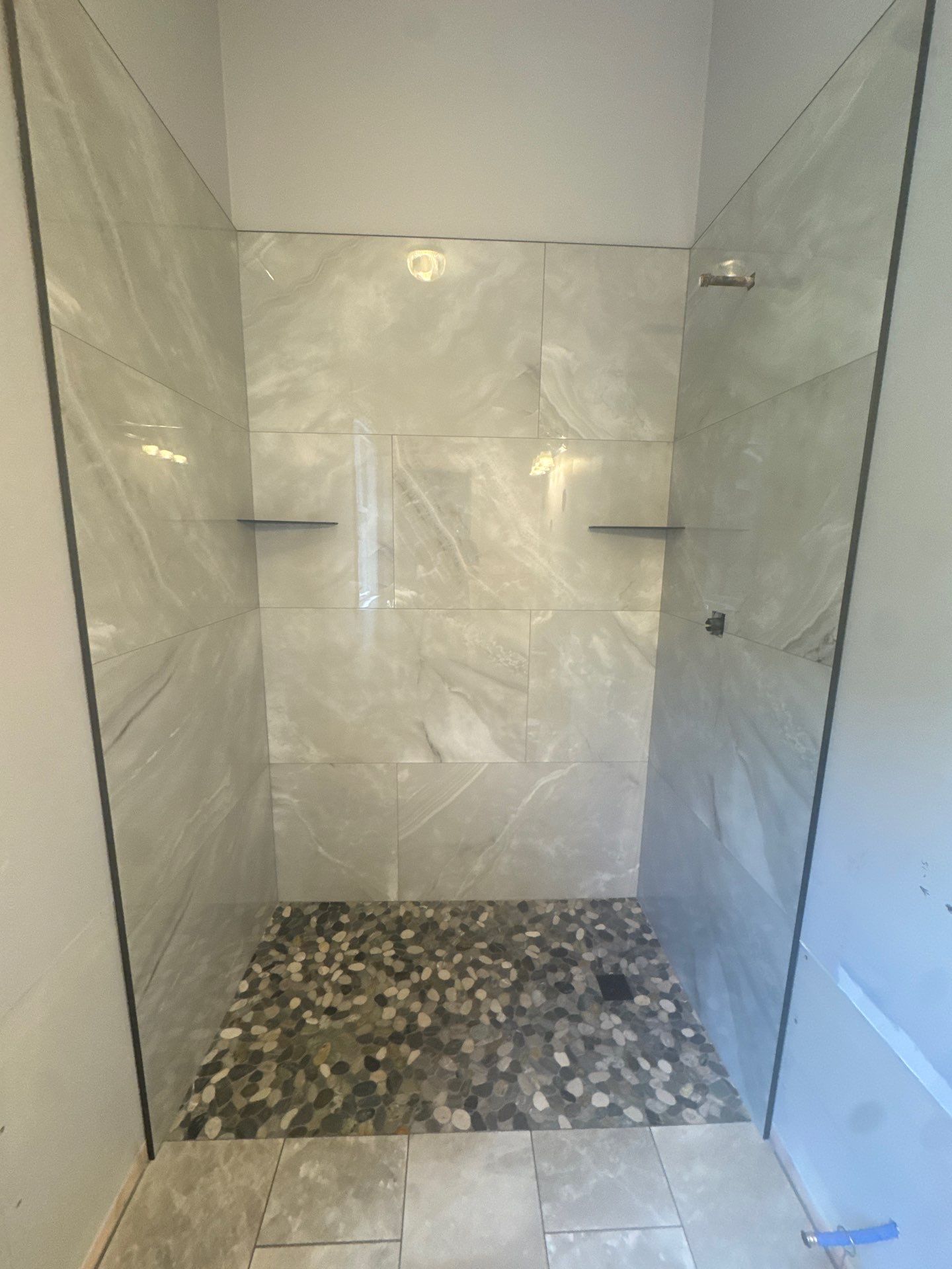 Marietta Bathroom Remodel with Marble Tile and Pebble Floor by Swift Home Renovations