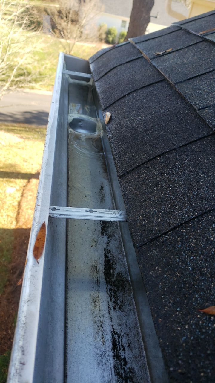 Sara Gutter cleanout using water by Power Wash Masters LLC