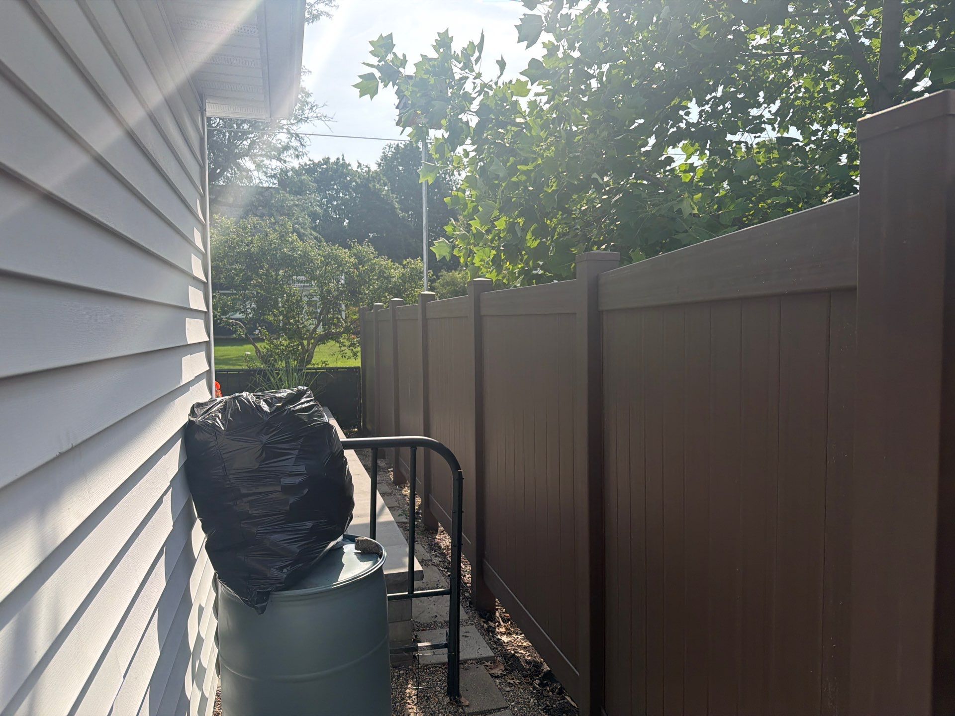 Walnut Vinyl Privacy Fence Installation in Waterloo by Perfect Picket Fence and Stain