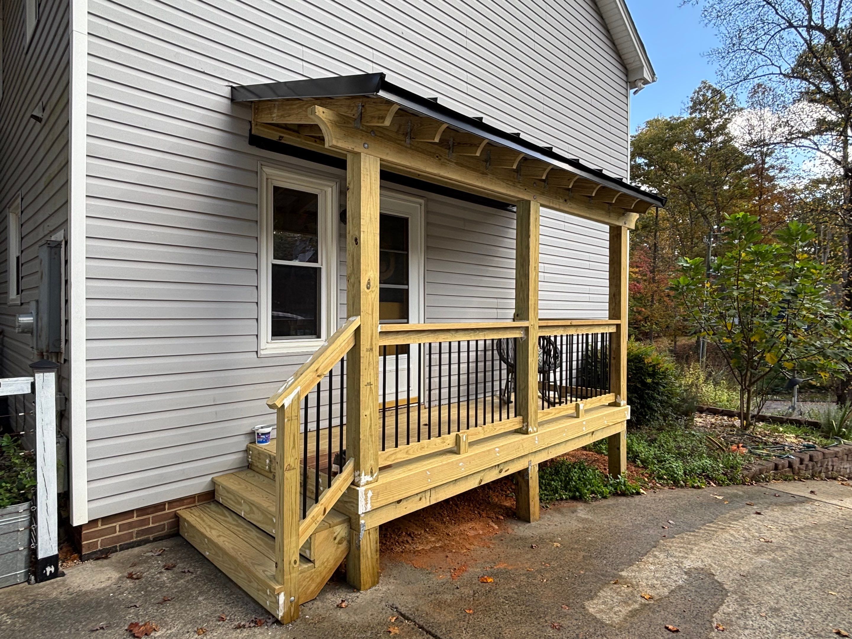Custom Pressure-Treated Deck and Metal Roof Installation in Durham by The Remodeling Company