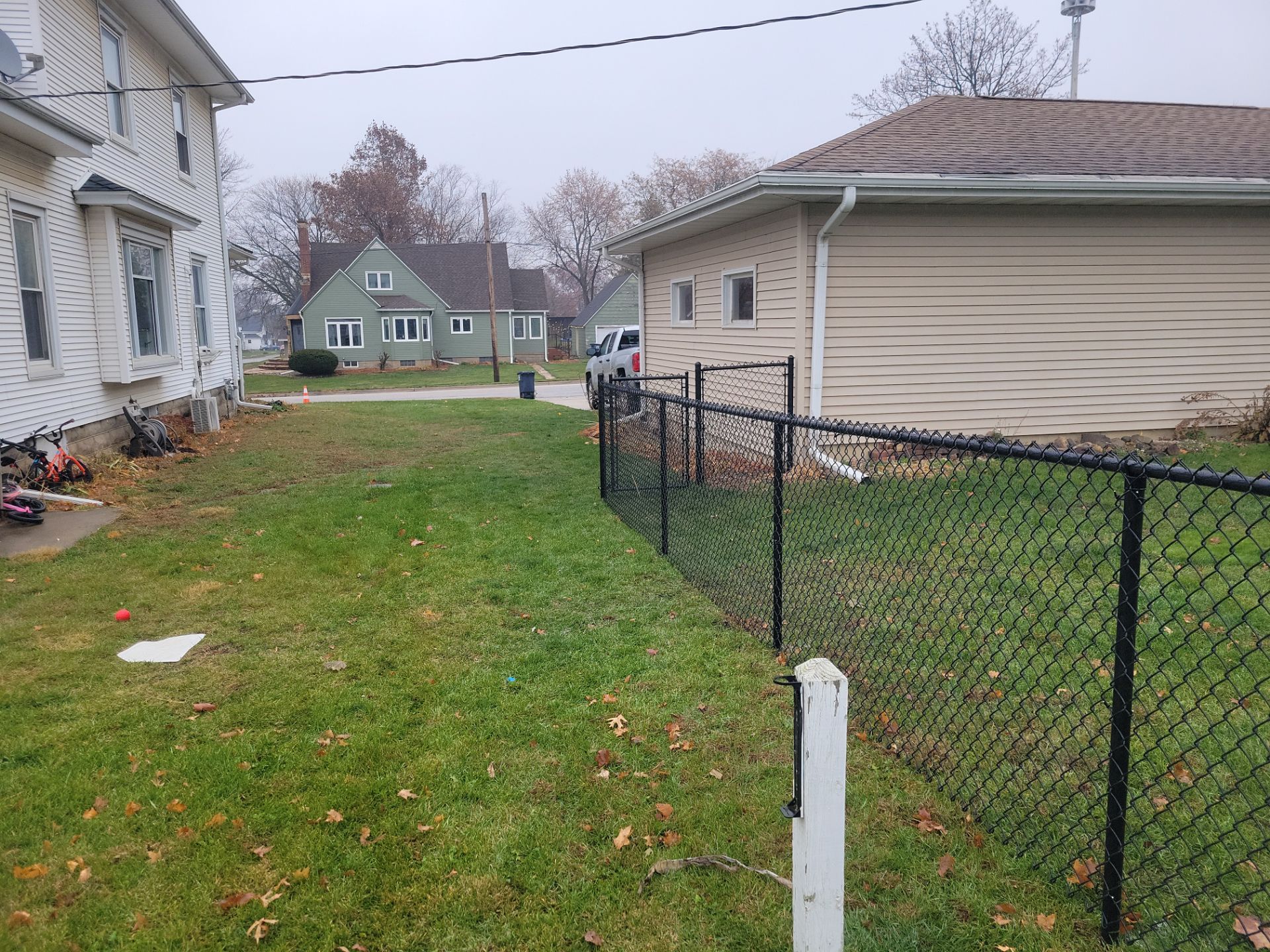 Black Vinyl-Coated Chain Link Fence Installation in Aplington by Perfect Picket Fence and Stain