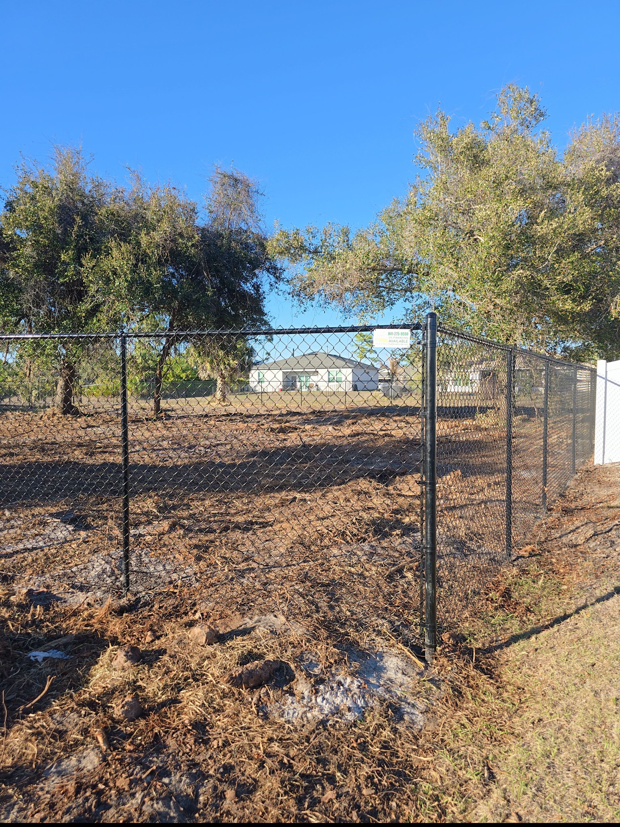 Black Vinyl-Coated Chain Link Fence and Gate Installation in North Port by True Fence LLC
