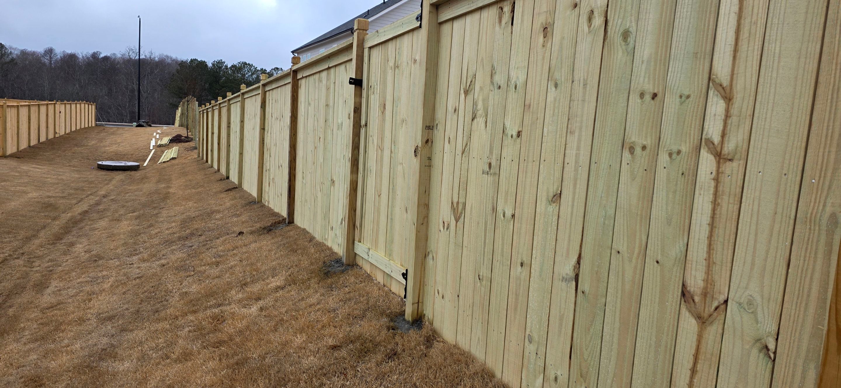 Fence Installation of Capped Wood Privacy with dado cut posts by Titans of Timber Fence & Stain
