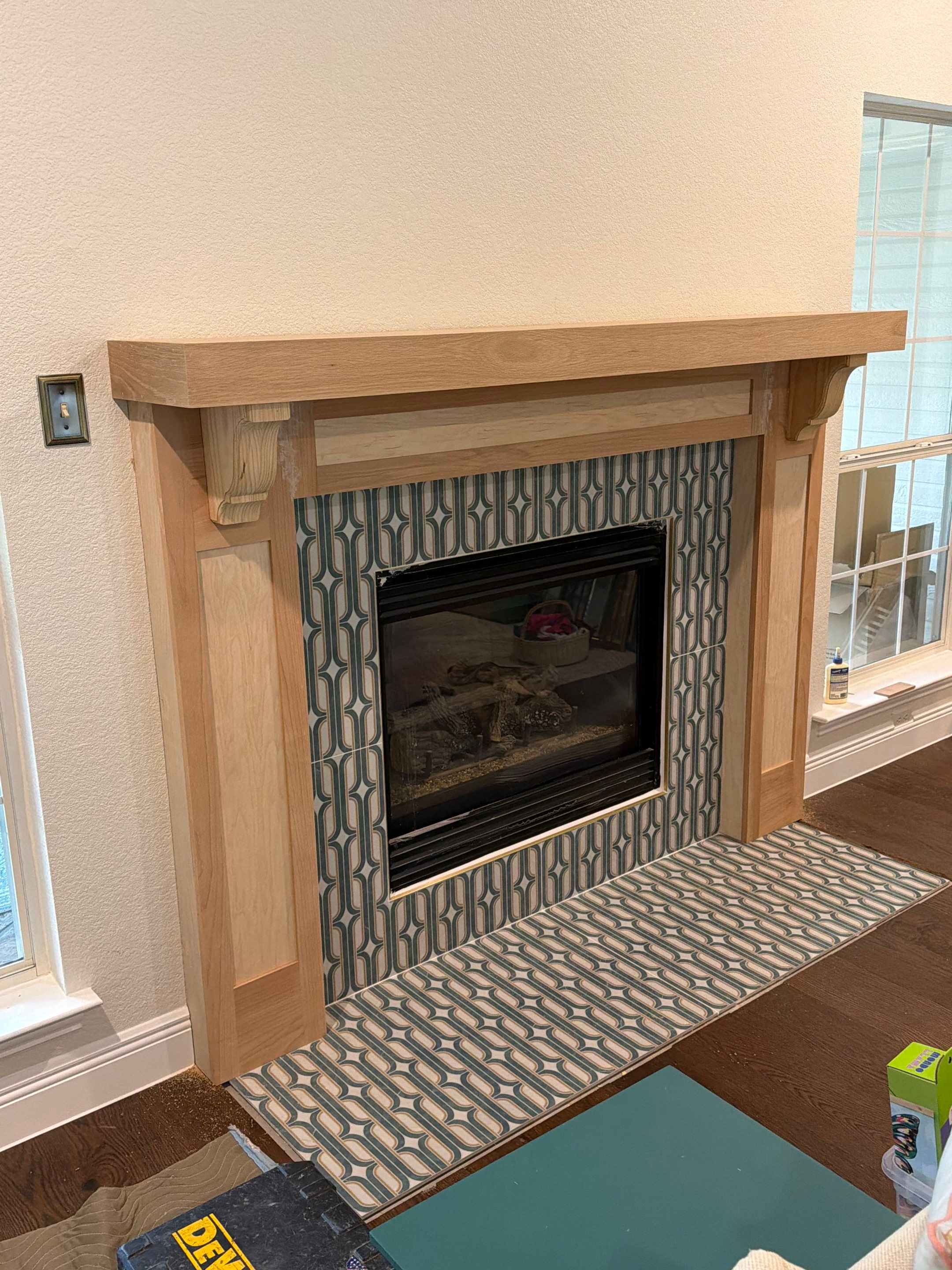 Interior Renovation with Dark Wood Floors and Geometric Fireplace Tile by Simmons Floors