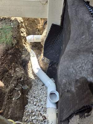 Burial of Sump Pump and Down Spout Discharges and Partial Waterproofing of Wall