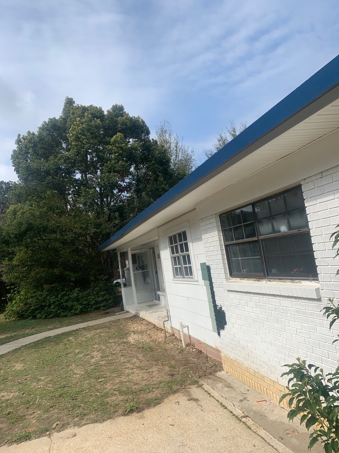 White Seamless Gutters and Black Downspouts by Gutter Professors