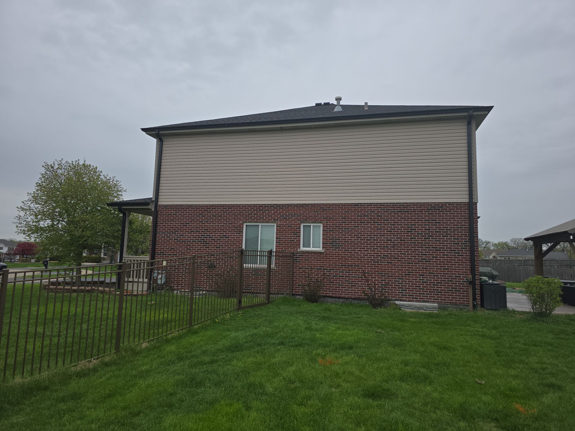 New black gutters and roof by Optimal Home Improvement 