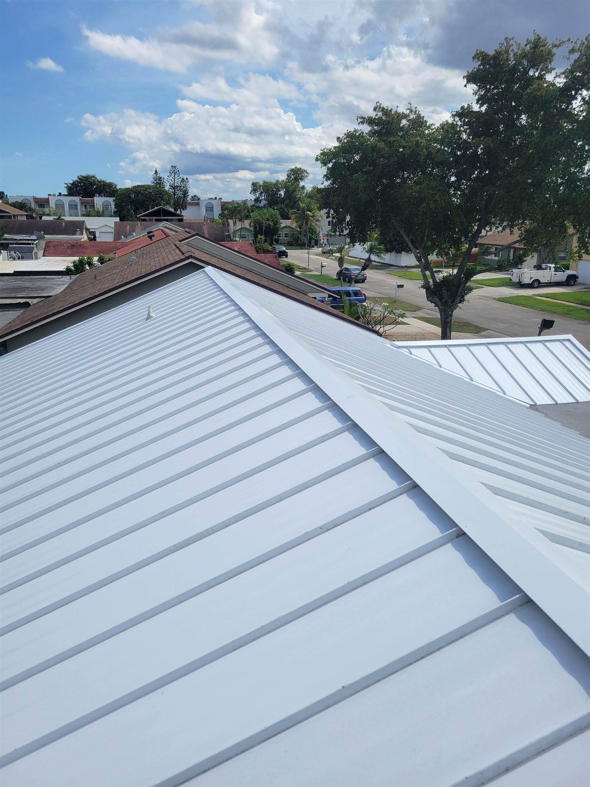 Standing Seam Metal & Flat Re-Roof using 1.5" Nail Strip 24ga Solar White Kynar Coated Standing Seam Metal Panels by Morton Roofing, Inc.