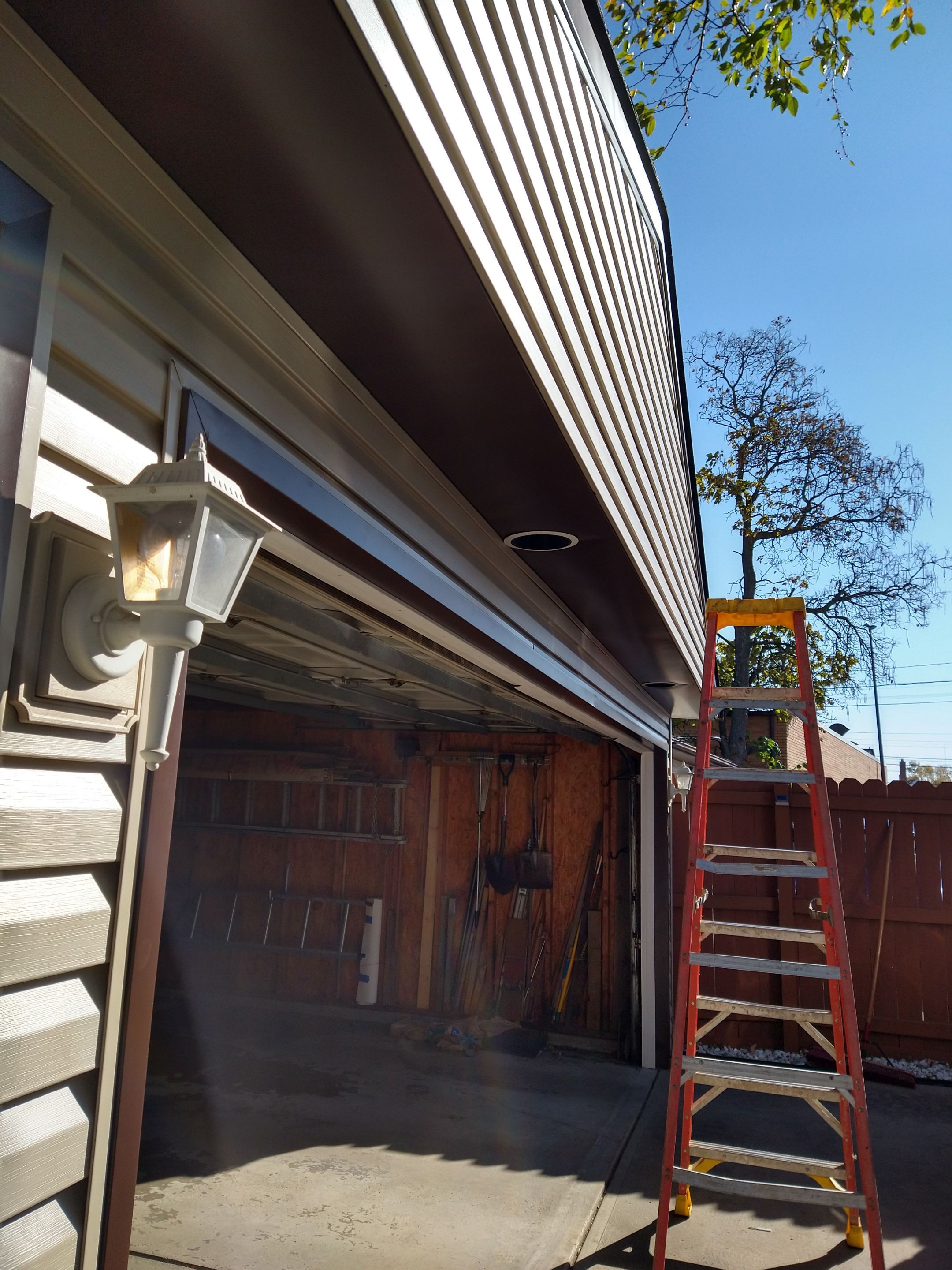 Siding Installation using Norandex woodsman dl-5 white woodgrain vinyl by Absolute Roofing and Construction