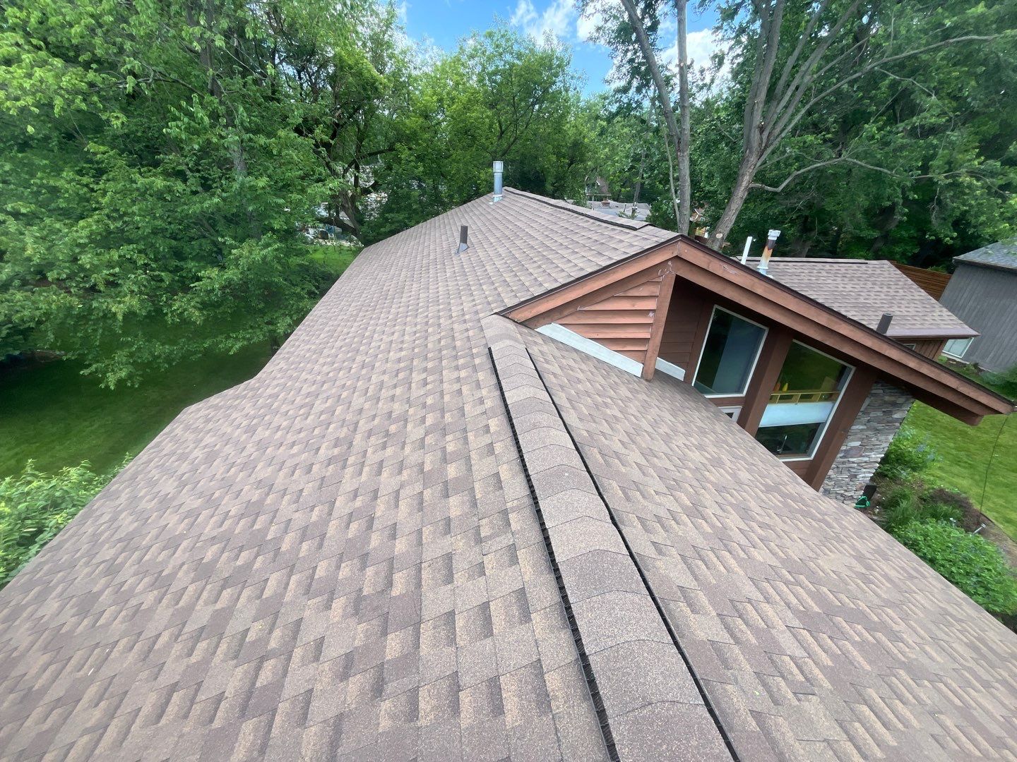 Installing new Roof and Gutter Protection after Hail Damage by Acme Exteriors