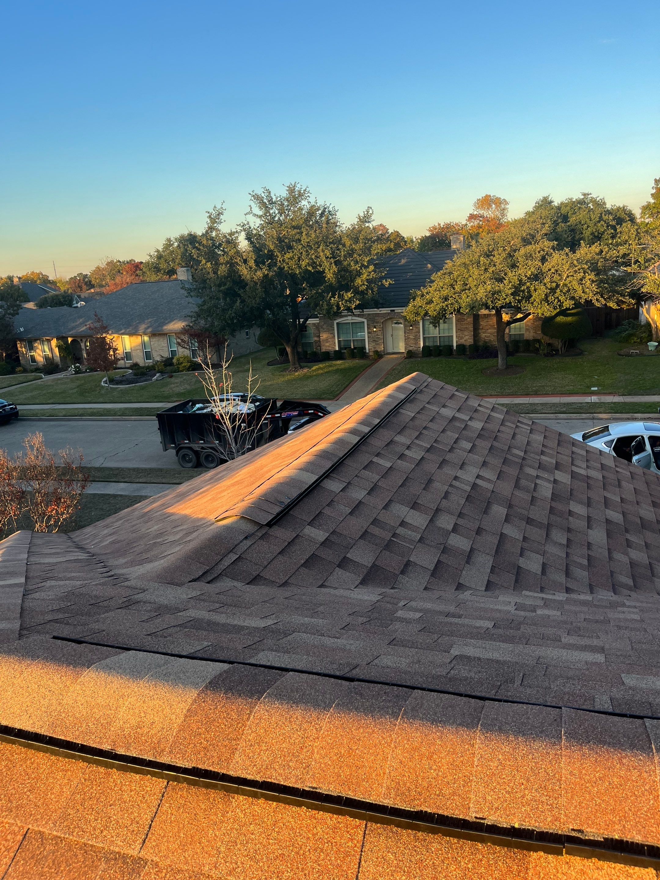 Brick with white area around windows with Malarkey Sienna Blend by Tejas Roofworks + Restoration
