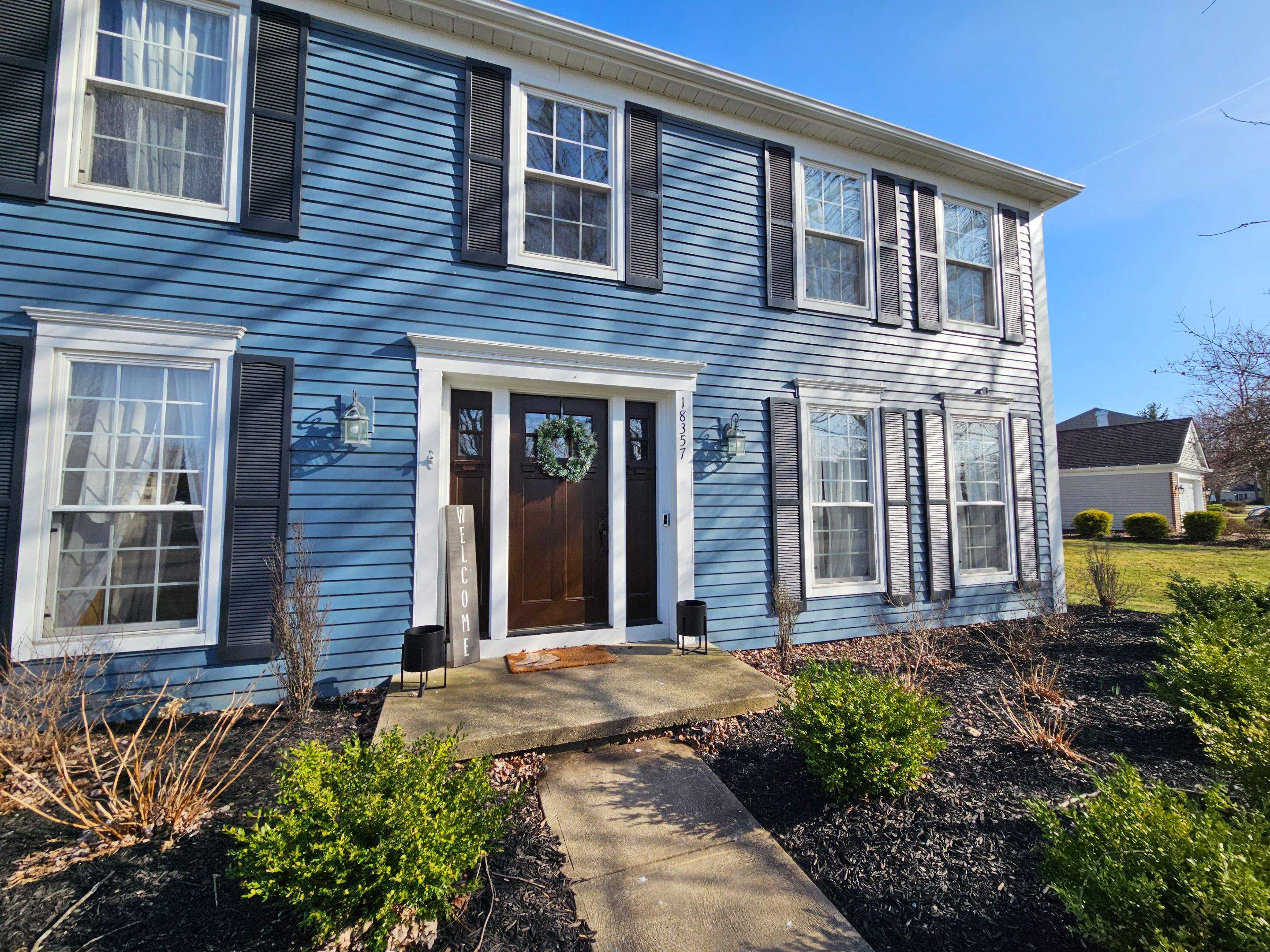 Vinyl Siding w. Stone Facade by Absolute Roofing and Construction